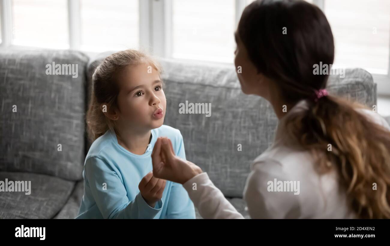 Small girl child pronounce sounds with speech therapist Stock Photo