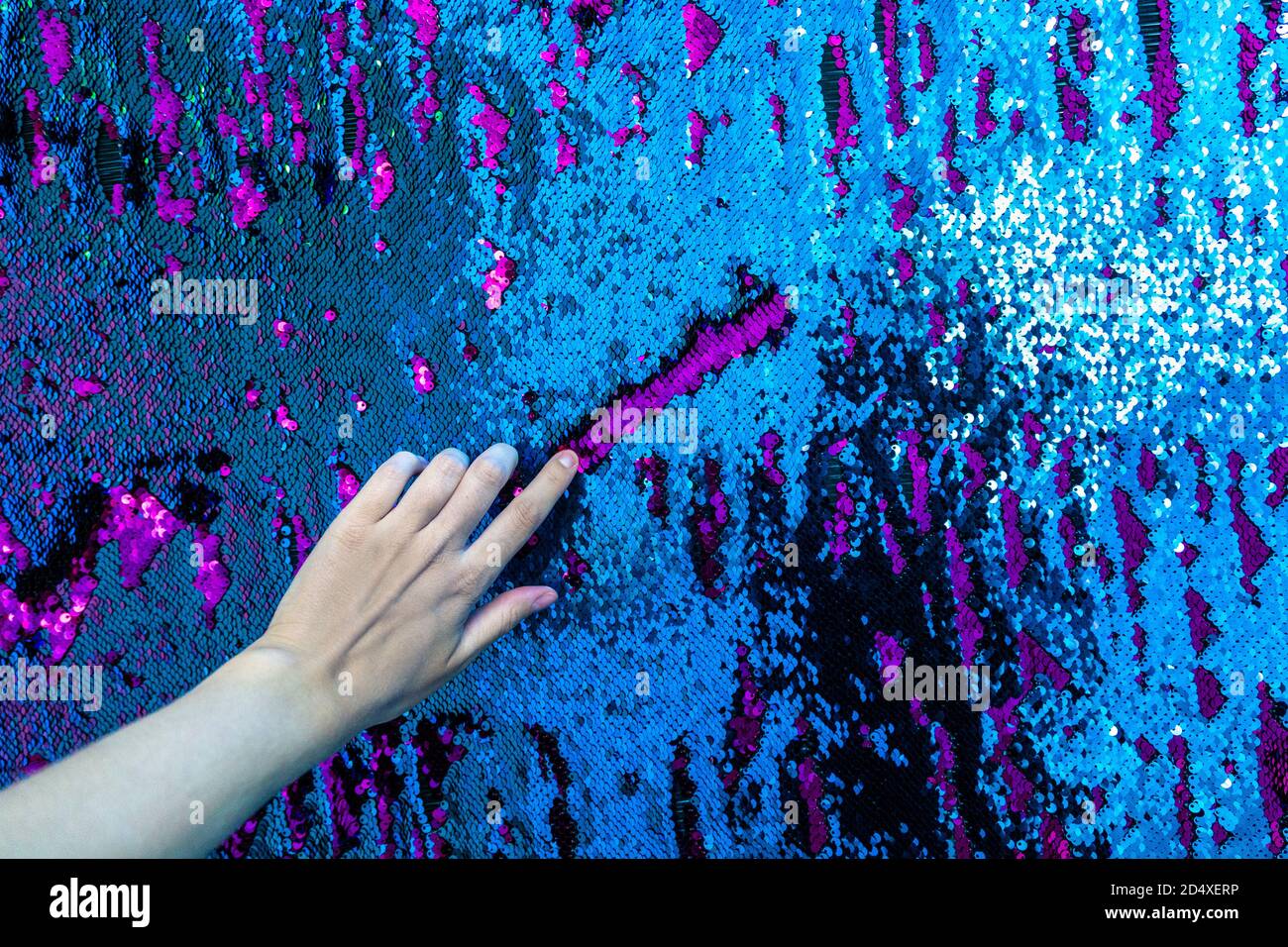Hand drawing on sequinned wall at Cosmos Muzeum - immersive museum of illussions, Warsaw, Poland Stock Photo