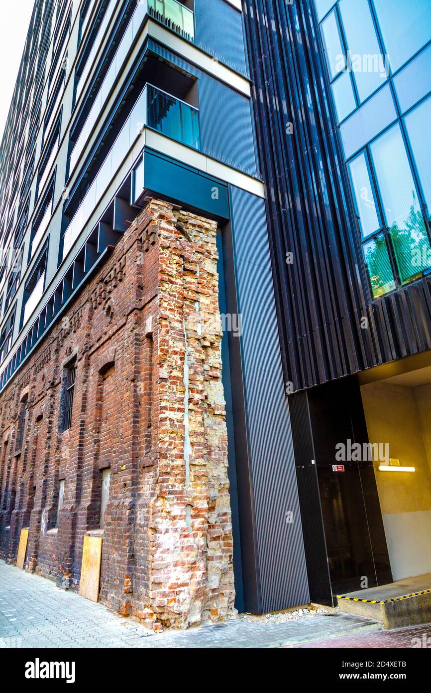 Remains of World War II ghetto wall incorporated into a modern building in Warsaw, Poland Stock Photo