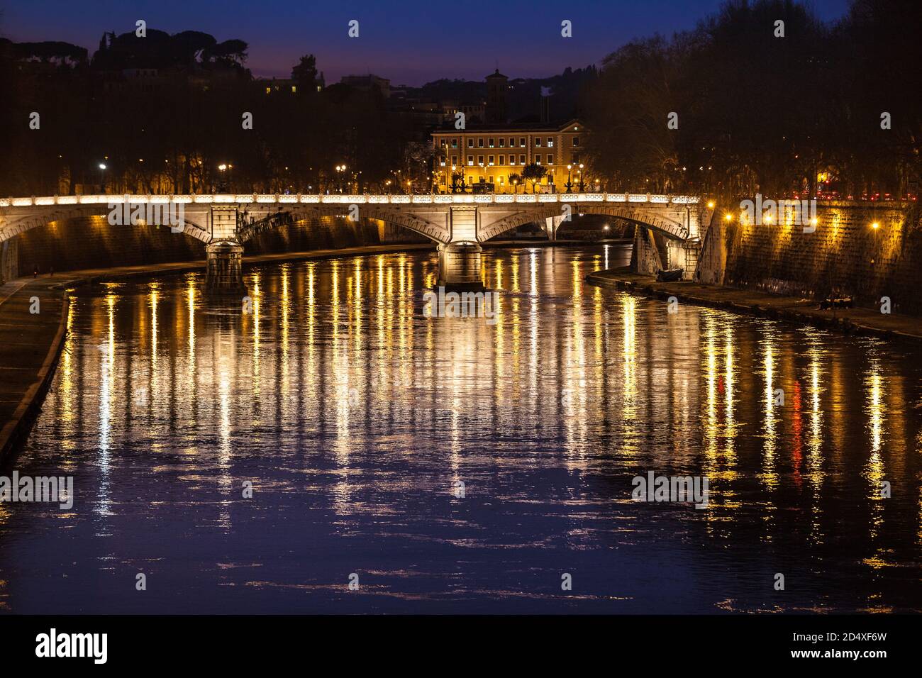 Tiber River, bridge. Ponte Giuseppe Mazzini. Reflections on water. Night. Rome, Italy. Historical building at the top. Stock Photo