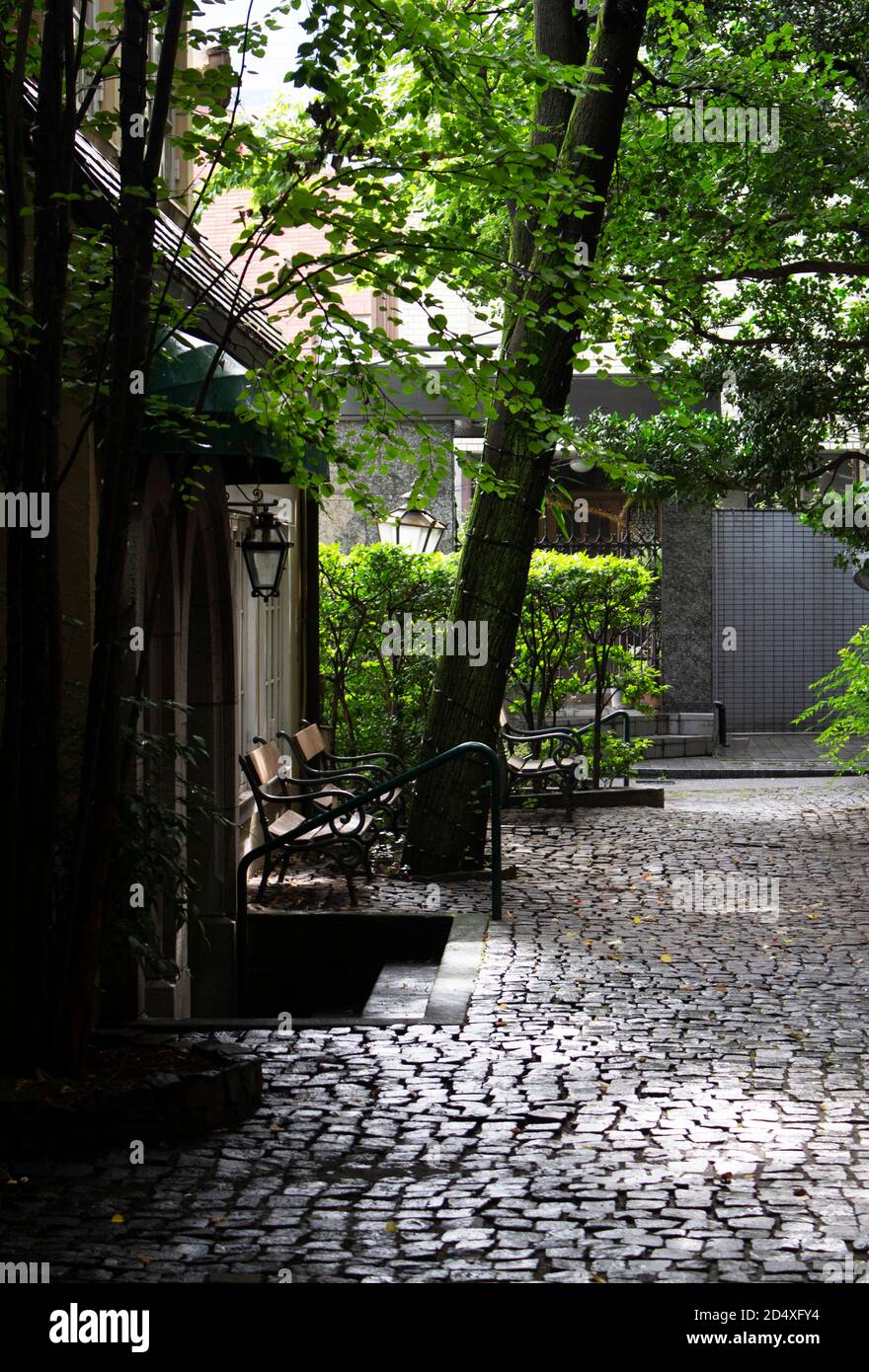European style cobblestone courtyard with antique benches Stock Photo