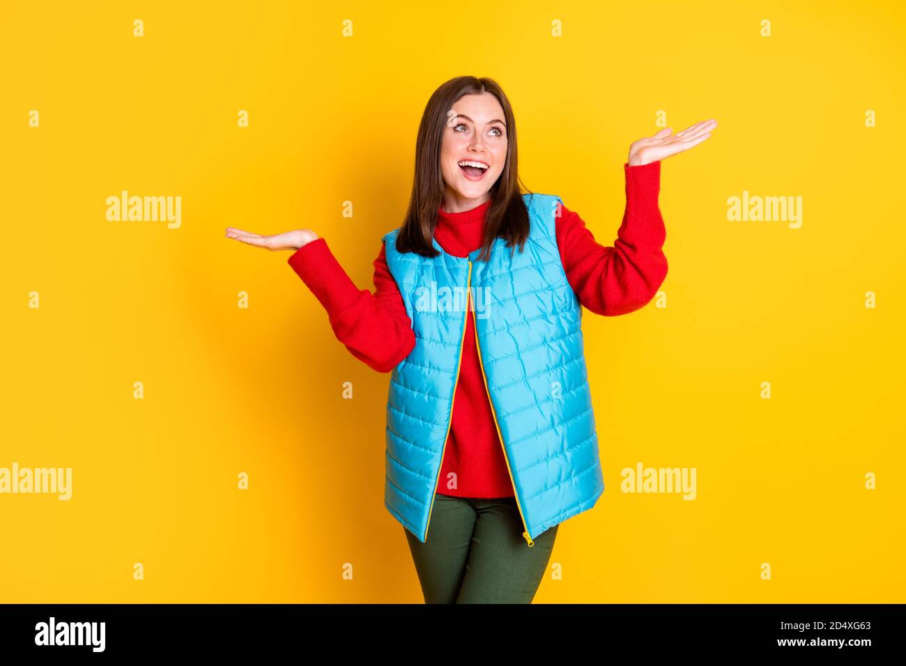 Photo of surprised girl have season walk hold hands impressed snowflakes falling copyspace wear good look outfit isolated over bright shine color Stock Photo