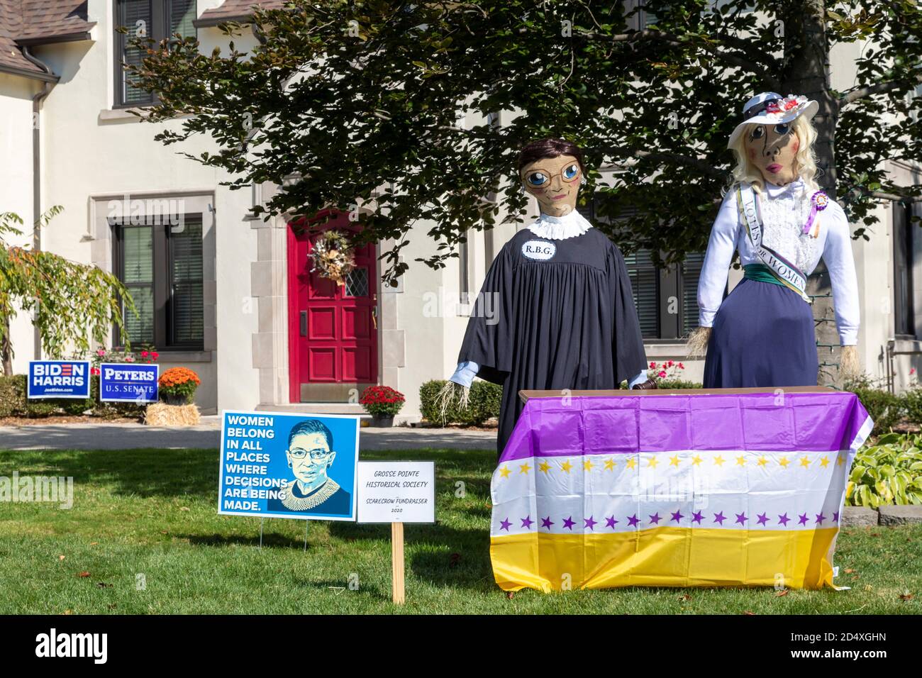 Grosse Pointe, Michigan, USA. 11th Oct, 2020. Representations of Ruth Bader Ginsburg and a suffragette on the lawn of a home weeks before the 2020 presidential election. The 19th Amendment was ratified 100 years ago, giving women the right to vote. Credit: Jim West/Alamy Live News Stock Photo
