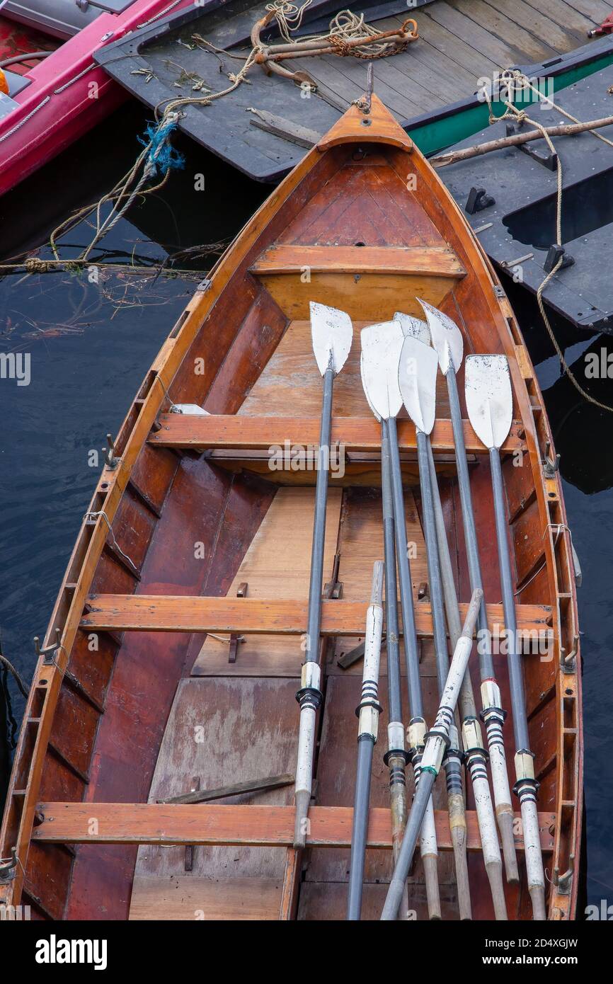 Oars in a wooden rowing boat for hire, moored on the River Thames, Richmond, Surrey, England Stock Photo