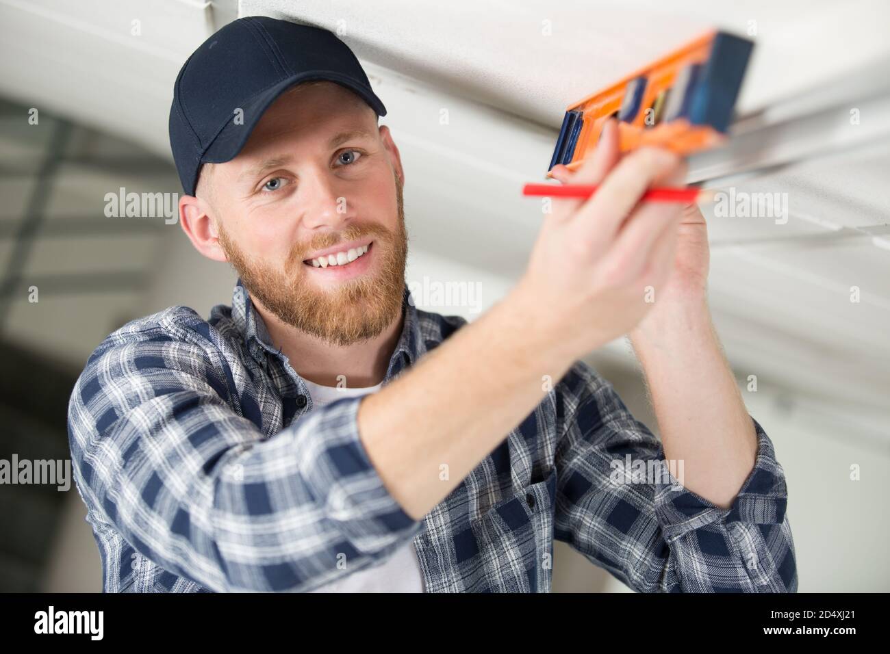 builder checking work with spirit level Stock Photo - Alamy