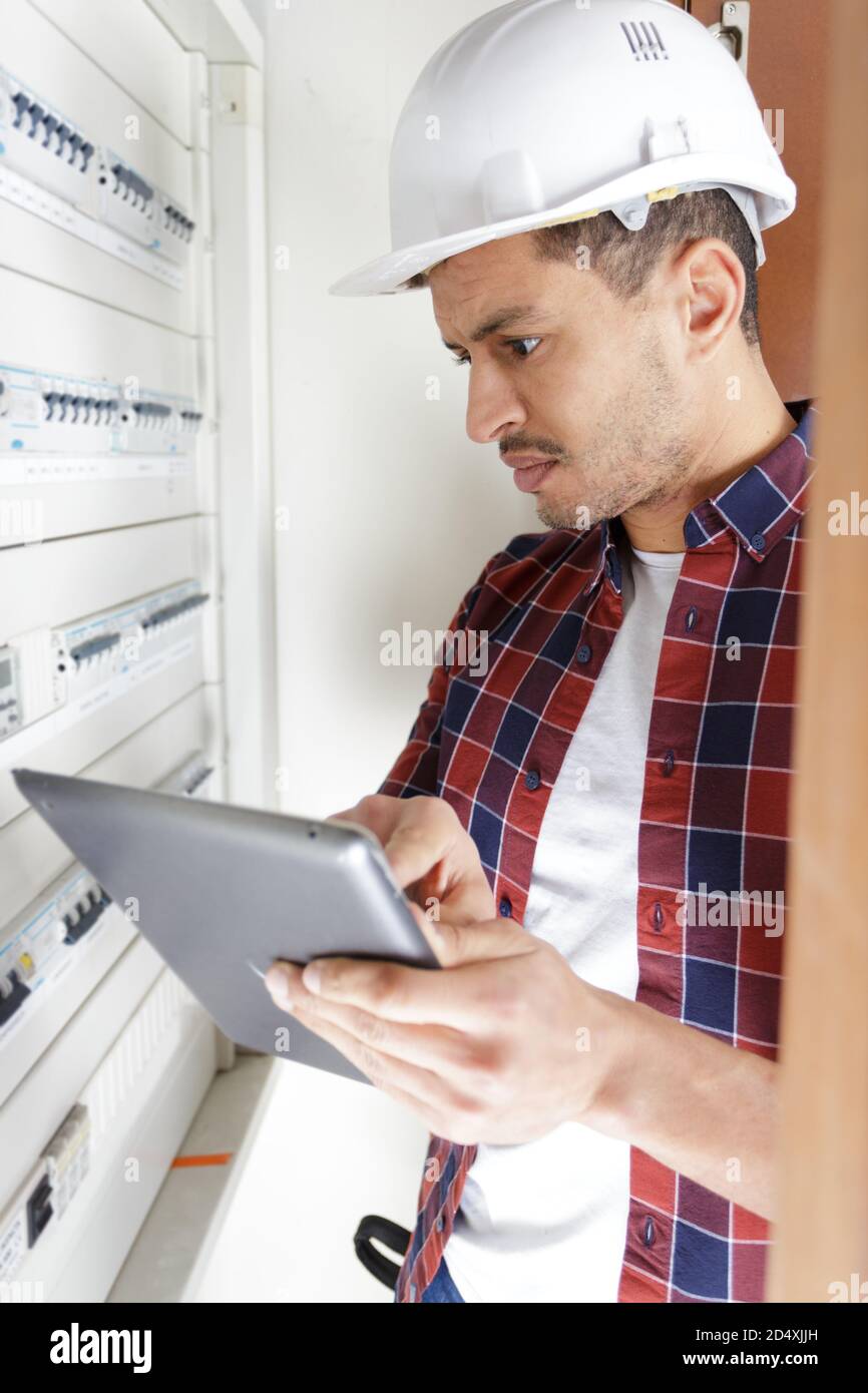electrician installing energy saving meter Stock Photo