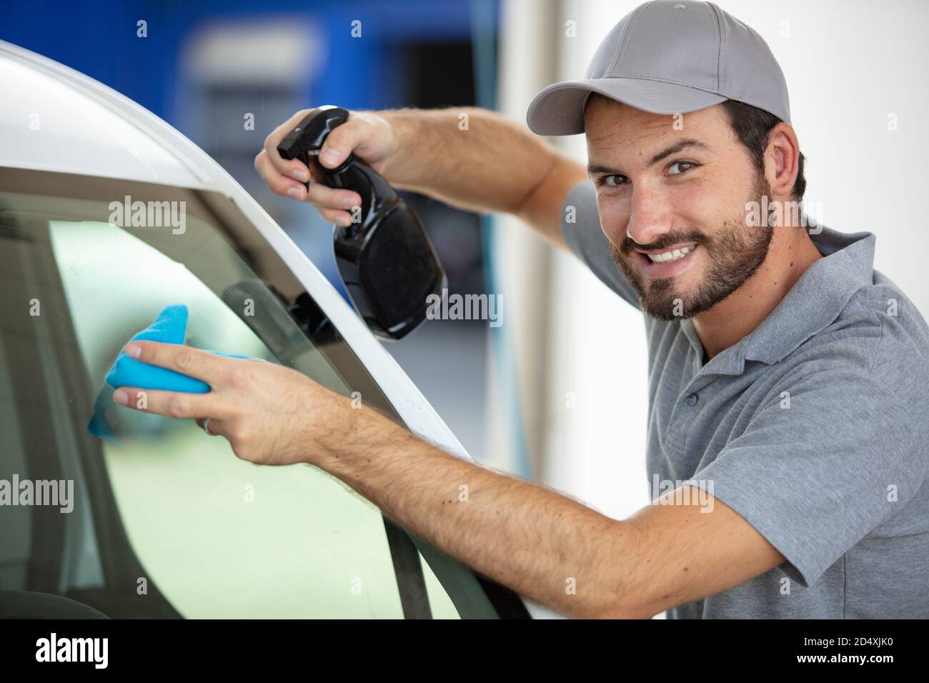 happy man cleaning car in auto show or salon Stock Photo Alamy