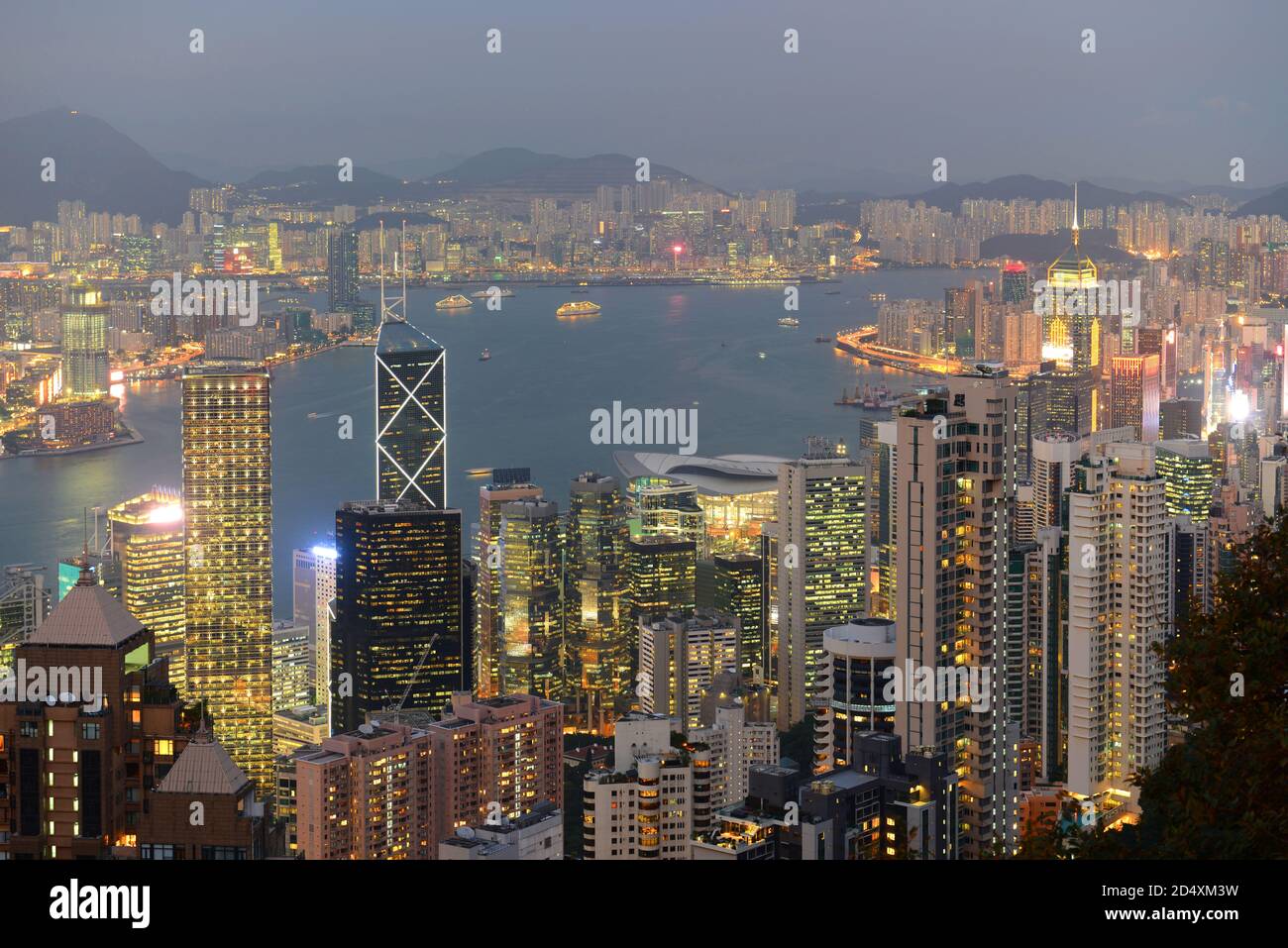Hong Kong Skyline and Victoria Harbour at dusk from Victoria Peak on Hong Kong Island, Hong Kong, China. Stock Photo