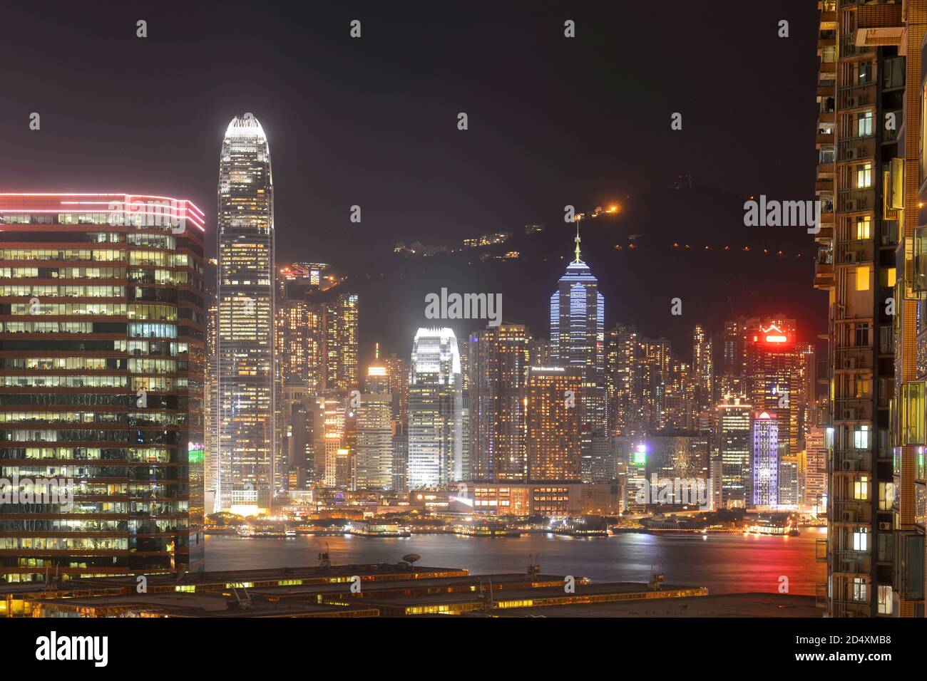 Hong Kong Skyline and Victoria Harbour at night from Tsim Sha Tsui on Kowloon in Hong Kong, China. Stock Photo