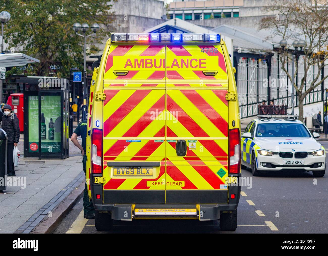 Ambulance paramedics attends an incident at Boots The Chemist, while police from WMP Traffic conduct a separate operation on Dale End, Birmingham Stock Photo