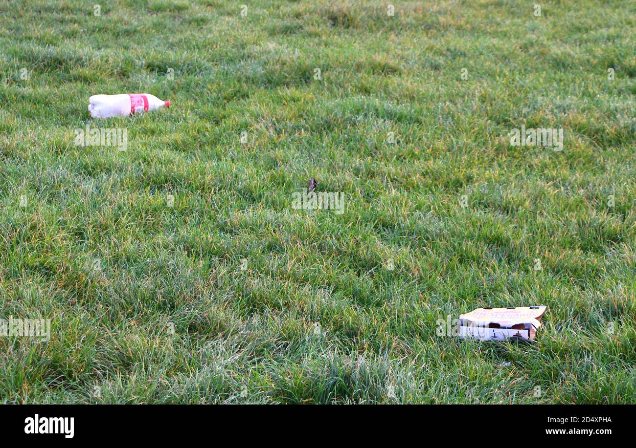 Litter left on grass with early morning dew on Riddlesdown public