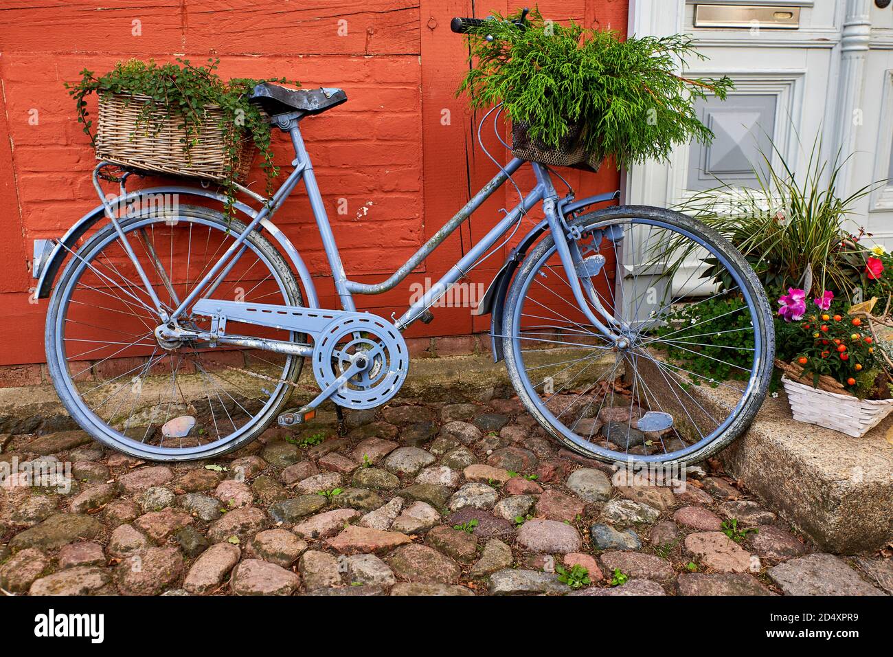 bike with decorative flower pot in front of a house Stock Photo - Alamy