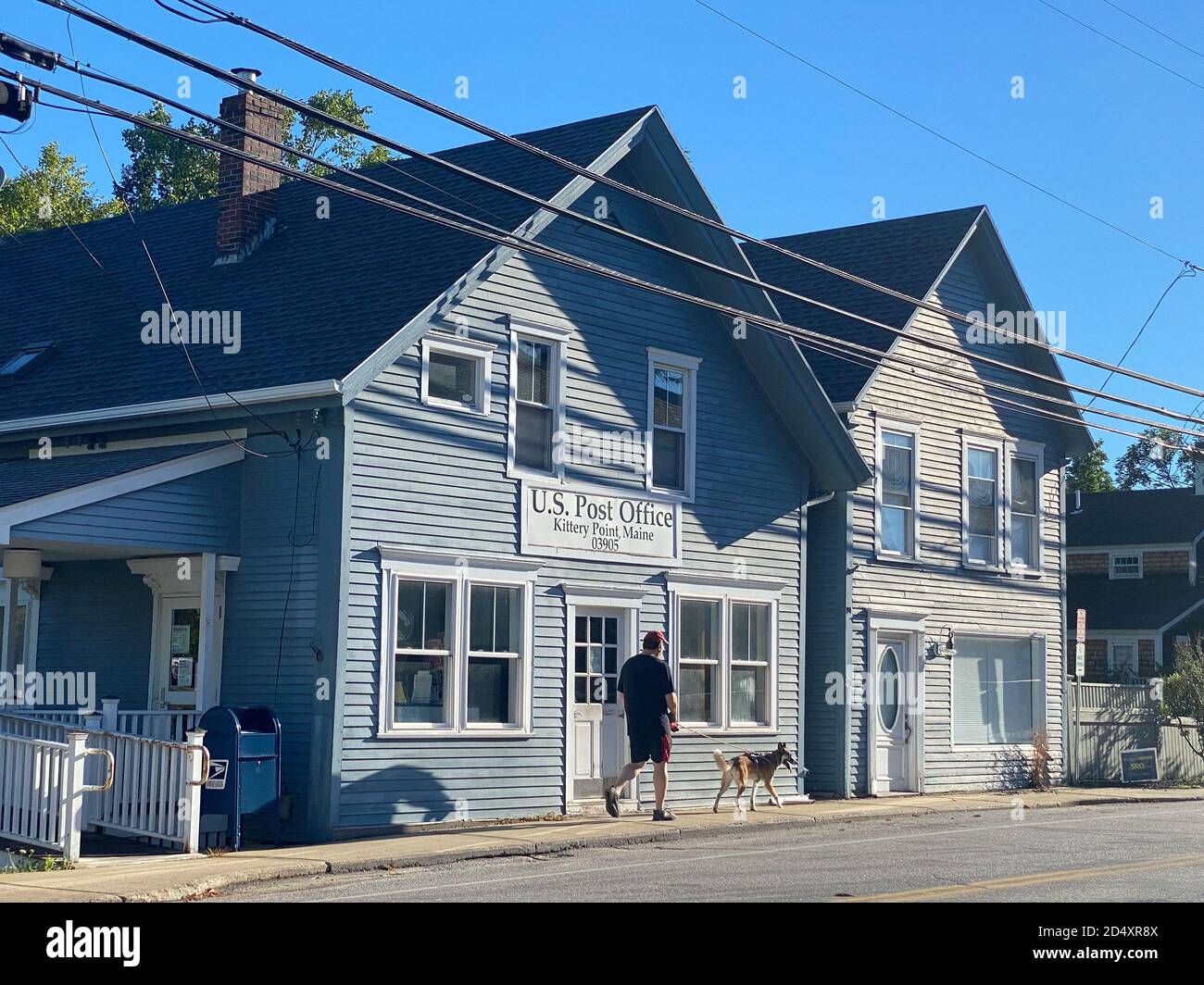 Post Office with Man walking Dog, Kittery Point, Maine, USA Stock Photo