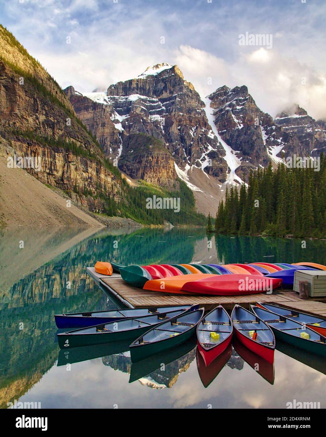 Moraine Lake with colorful boats in the foreground, Banff National Park, Alberta, Canada Stock Photo