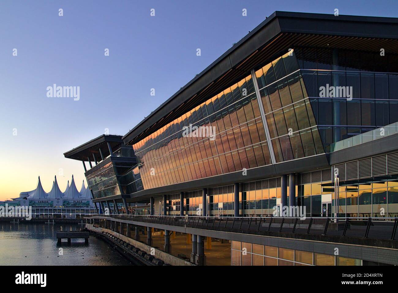 August 2020, Vancouver, British Columbia, Canada - Convention Center building with Canada Place in the background during sunrise, Vancouver Stock Photo