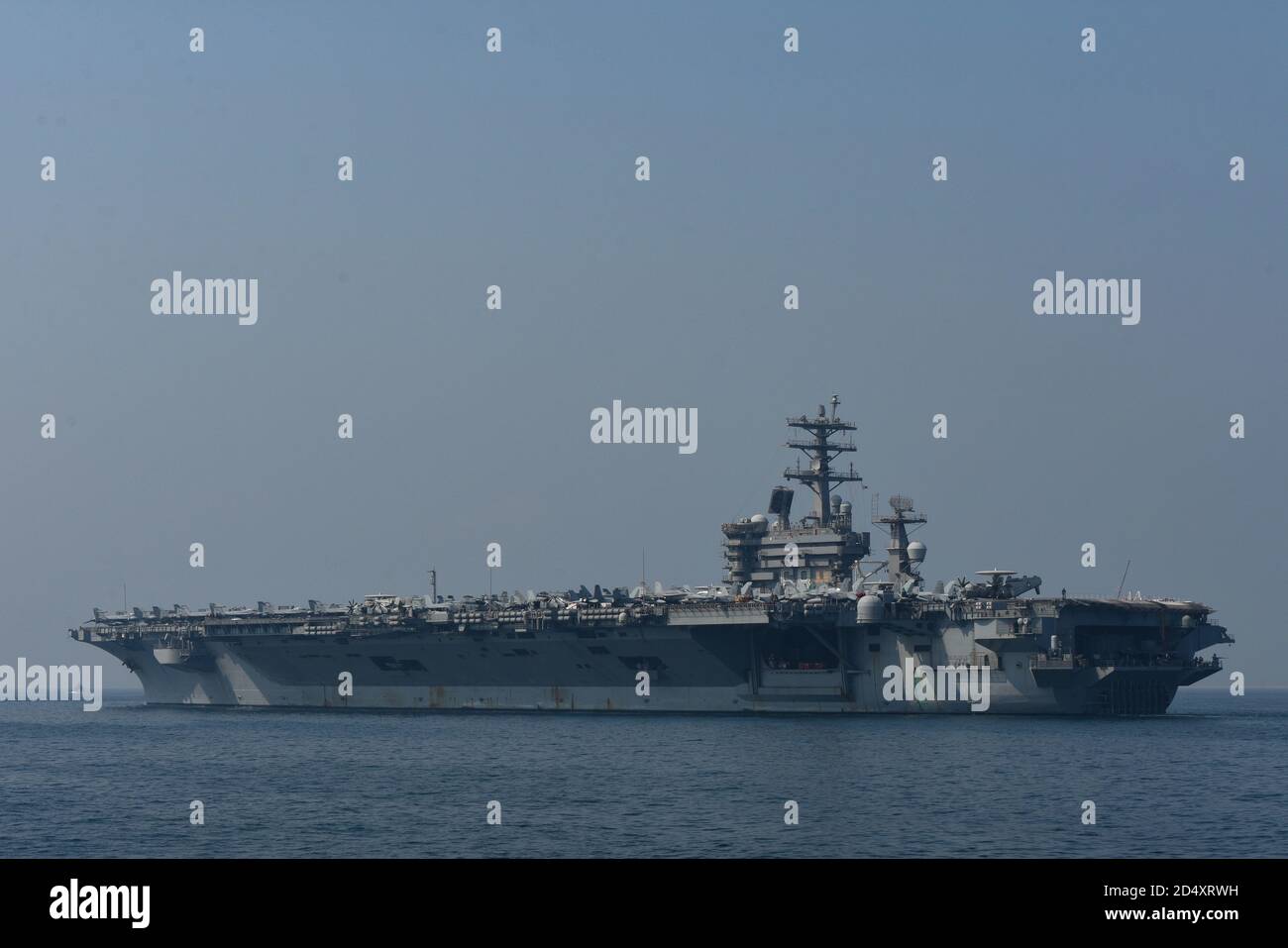 201007-A-FT904-1267 GULF OF BAHRAIN (Oct. 7, 2020) The aircraft carrier USS Nimitz (CVN 68) steams through the Gulf of Bahrain, inbound to a maintenance and logistics visit at Khalifa bin Salman Port, Bahrain, Oct. 7.  Nimitz, the flagship of Nimitz Carrier Strike Group, is deployed to the U.S. 5th Fleet area of operations, conducting missions in support of OIR, and maritime security operations alongside regional and coalition partners. (U.S. Army photo by Staff Sgt. Timothy Clegg) Stock Photo