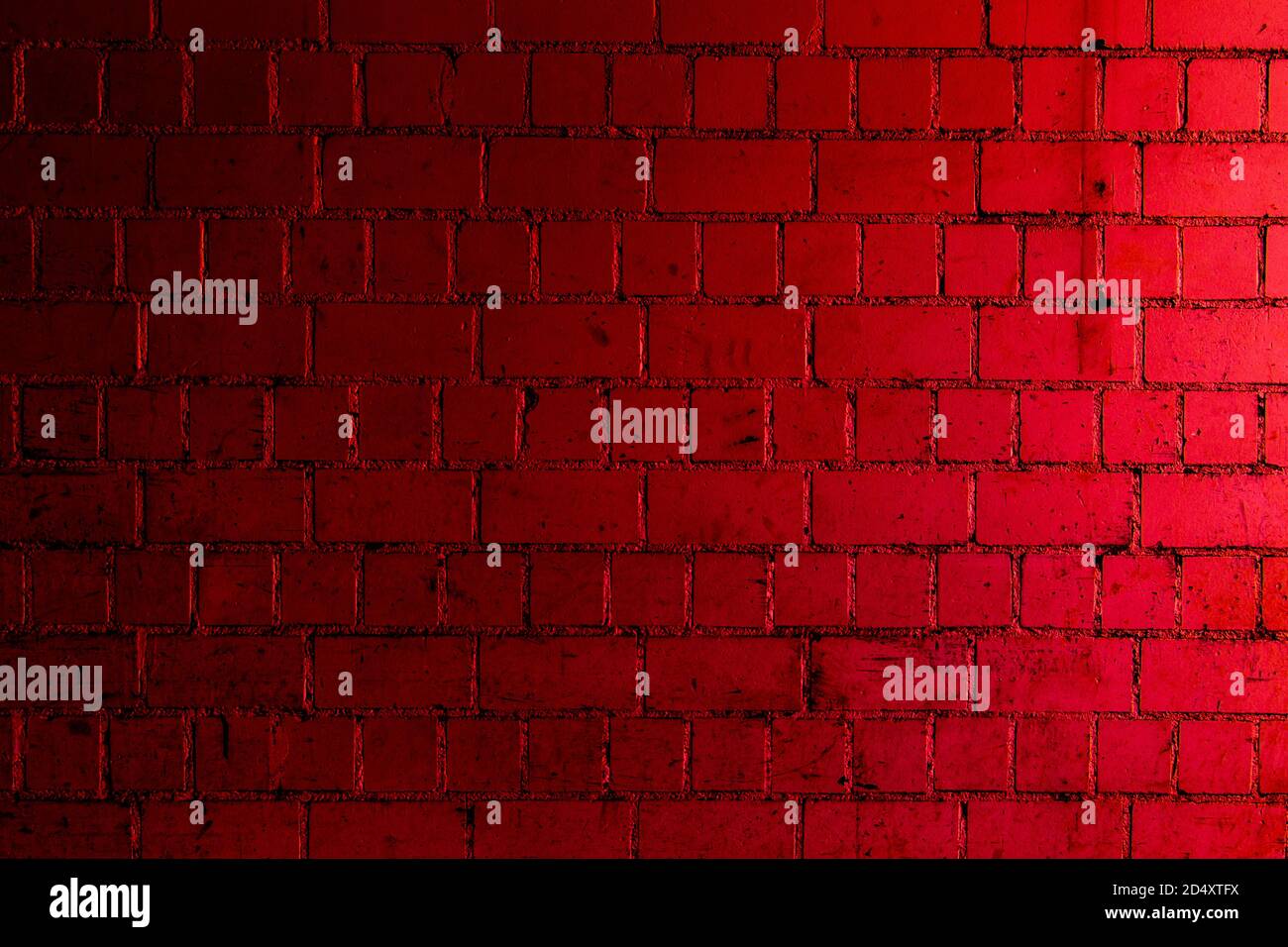 Red brick wall background with shades of light and dark crimson Stock