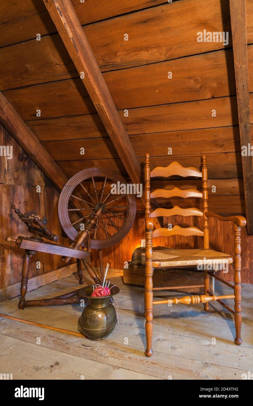 Antique wooden spinning wheel and chair in summer master bedroom