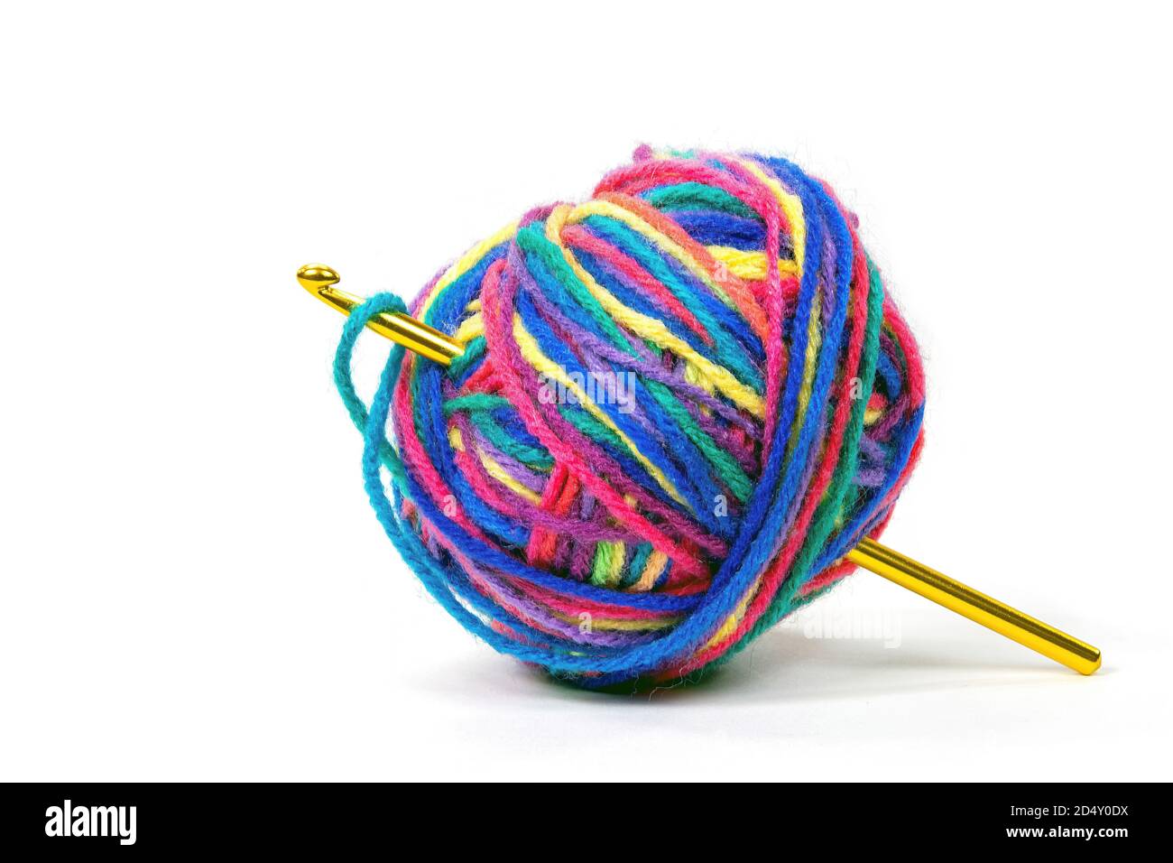 crochet hook in colorful ball of yarn isolated on white background Stock Photo