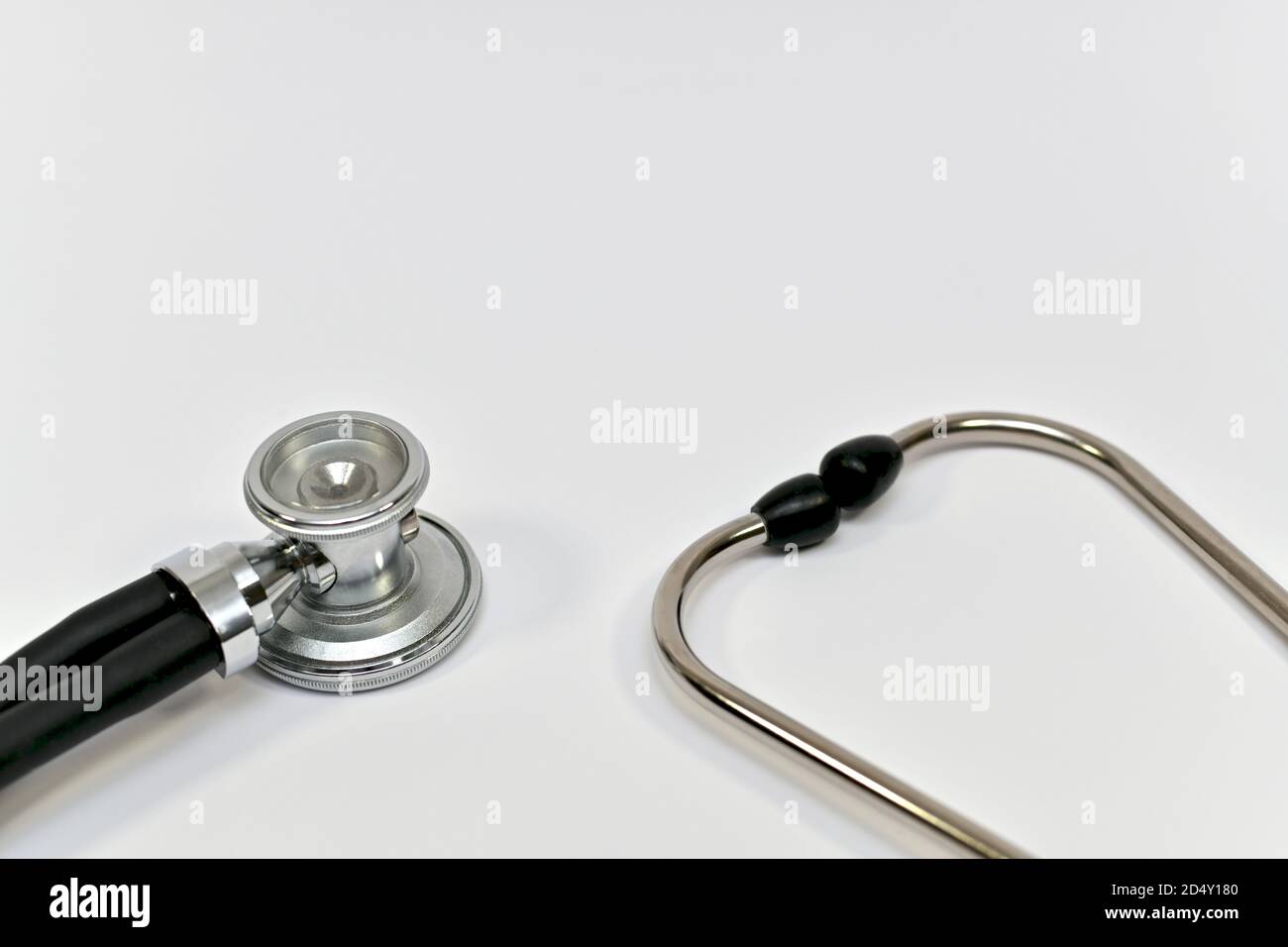 Two ends of a stethoscope, fragment closeup against a light background.  Stock Photo