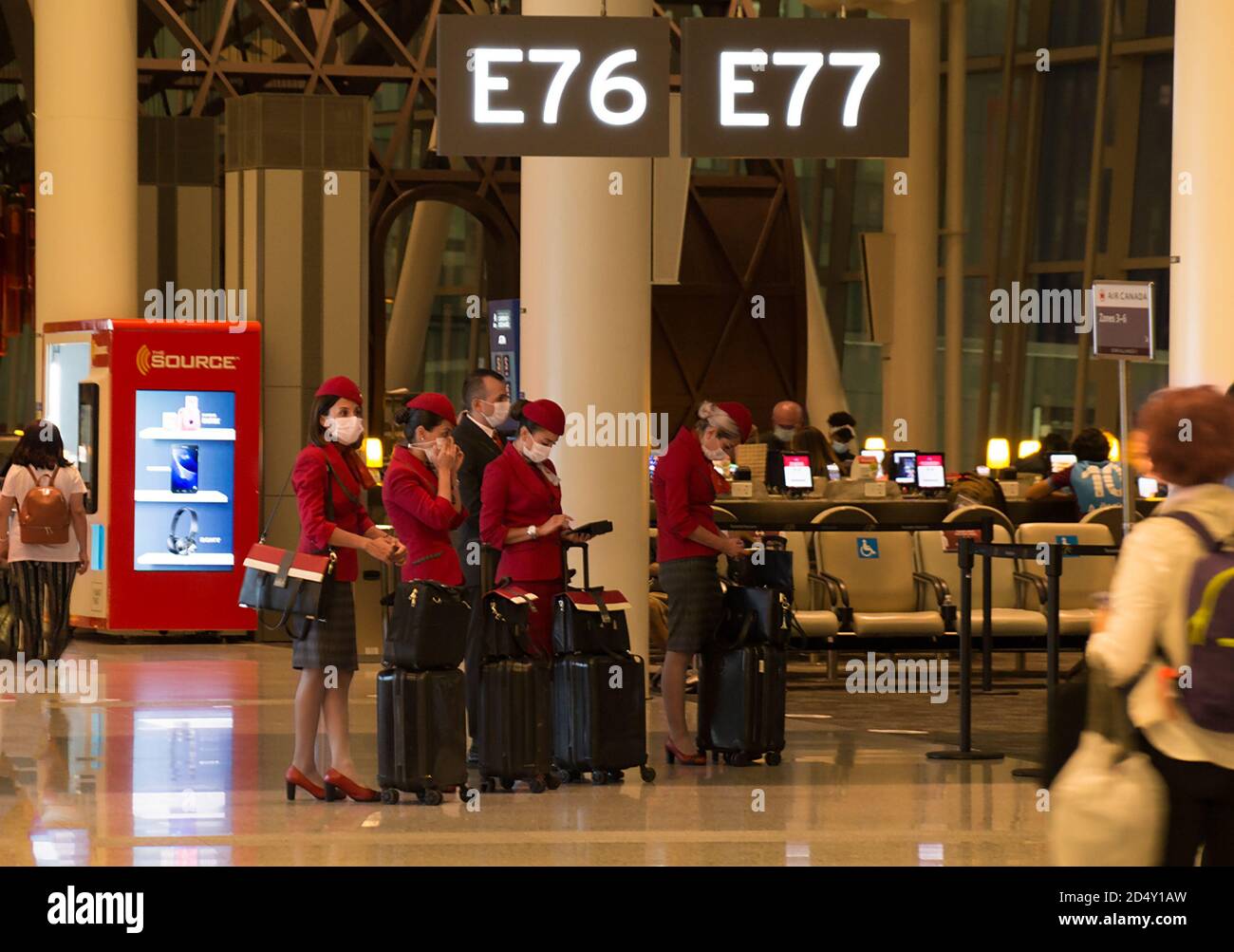 TORONTO, CANADA - 08 20 2020: Turkish Airlines flight crew wearing facial masks beside the gate in the empty night hall of Toronto Pearson Stock Photo