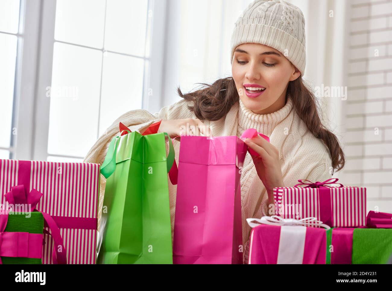 Beautiful young woman with gifts Stock Photo - Alamy