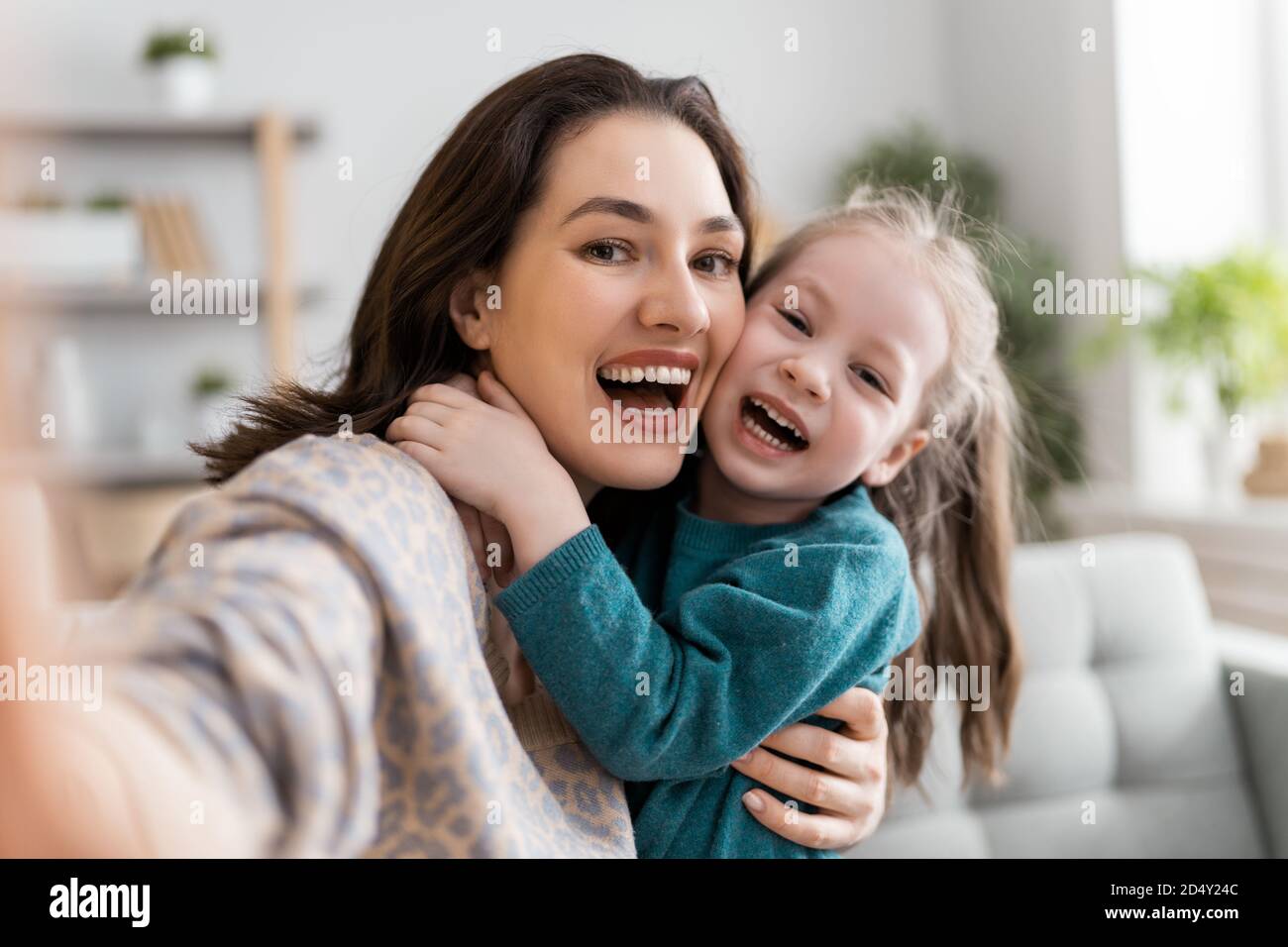 Happy loving family. Young mother and daughter girl using ...