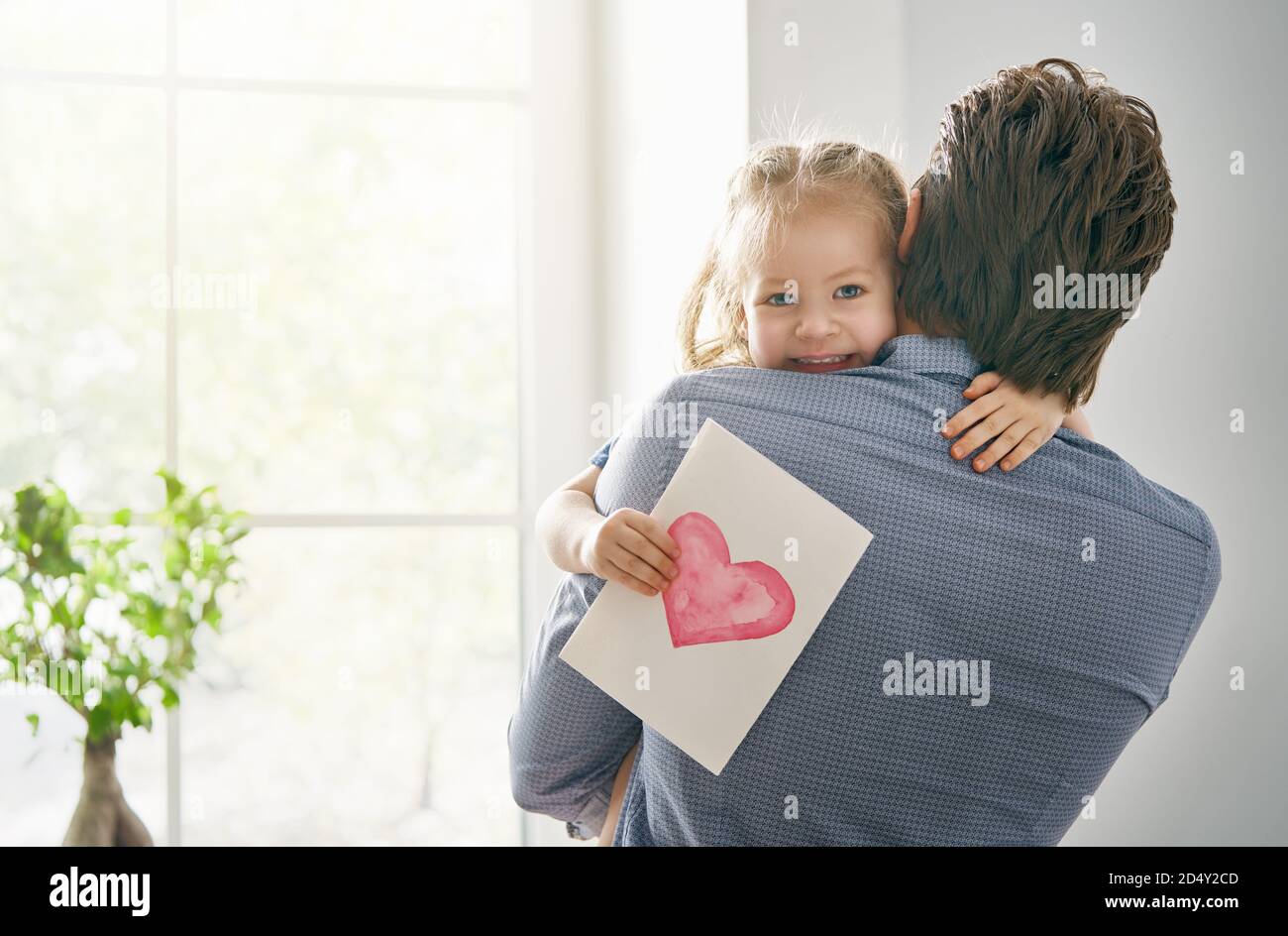 Happy father's day! Child daughter congratulating dad and giving him ...