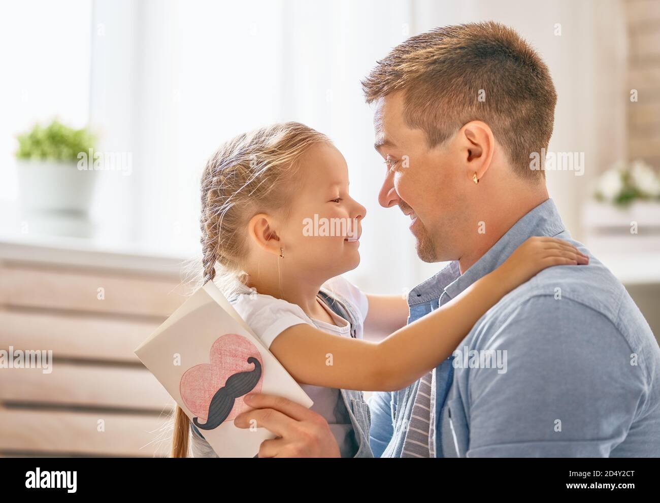 Happy father's day! Child daughter congratulating dad and giving him ...