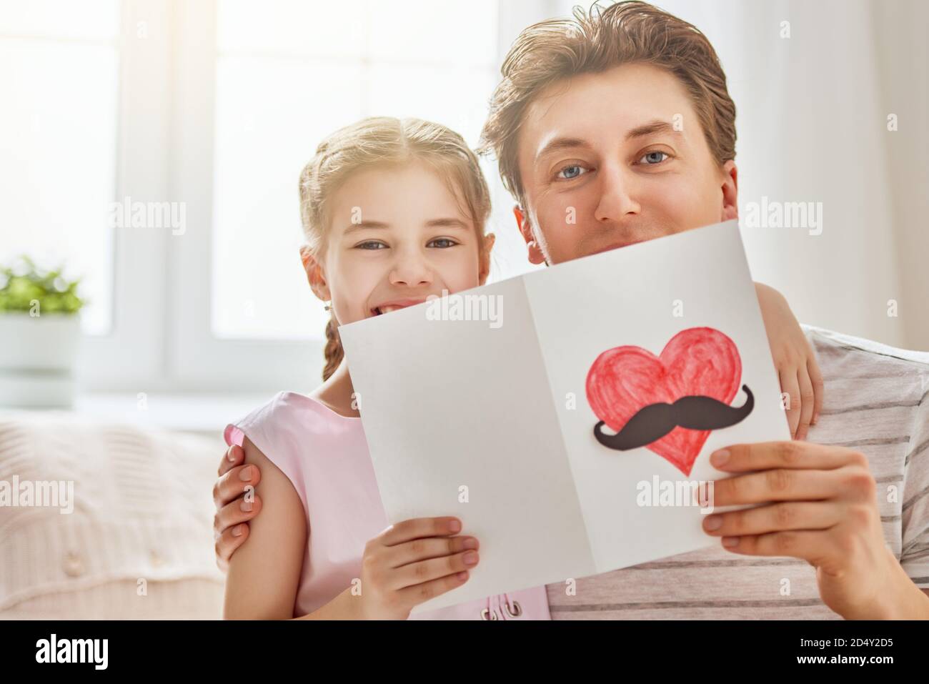 Happy father's day! Child daughter congratulates dad and gives him ...