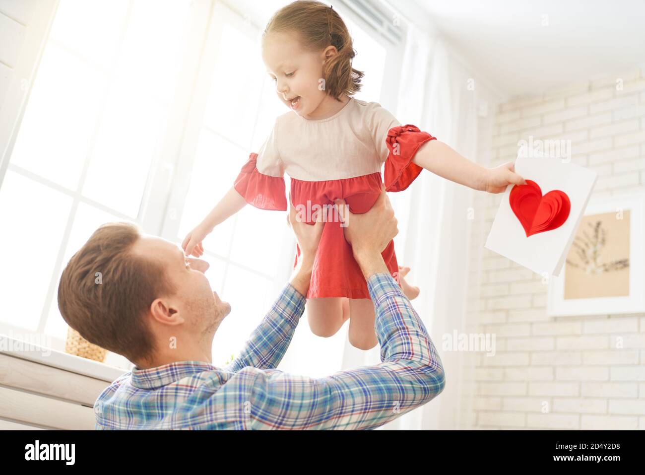 Happy father's day! Child daughter congratulating dad and giving him ...