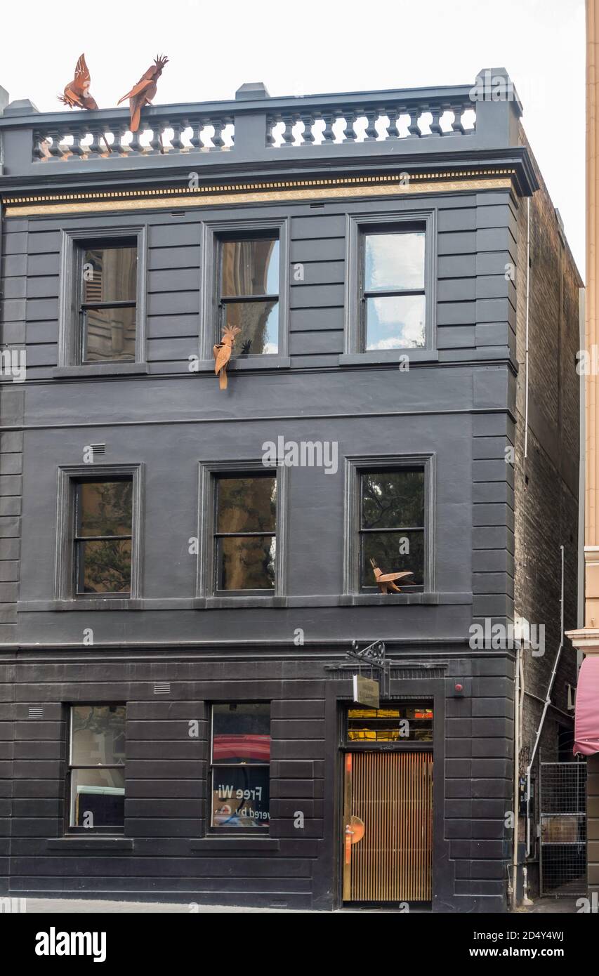 Steel Cockatoos on the facade of a renovated historic building in
