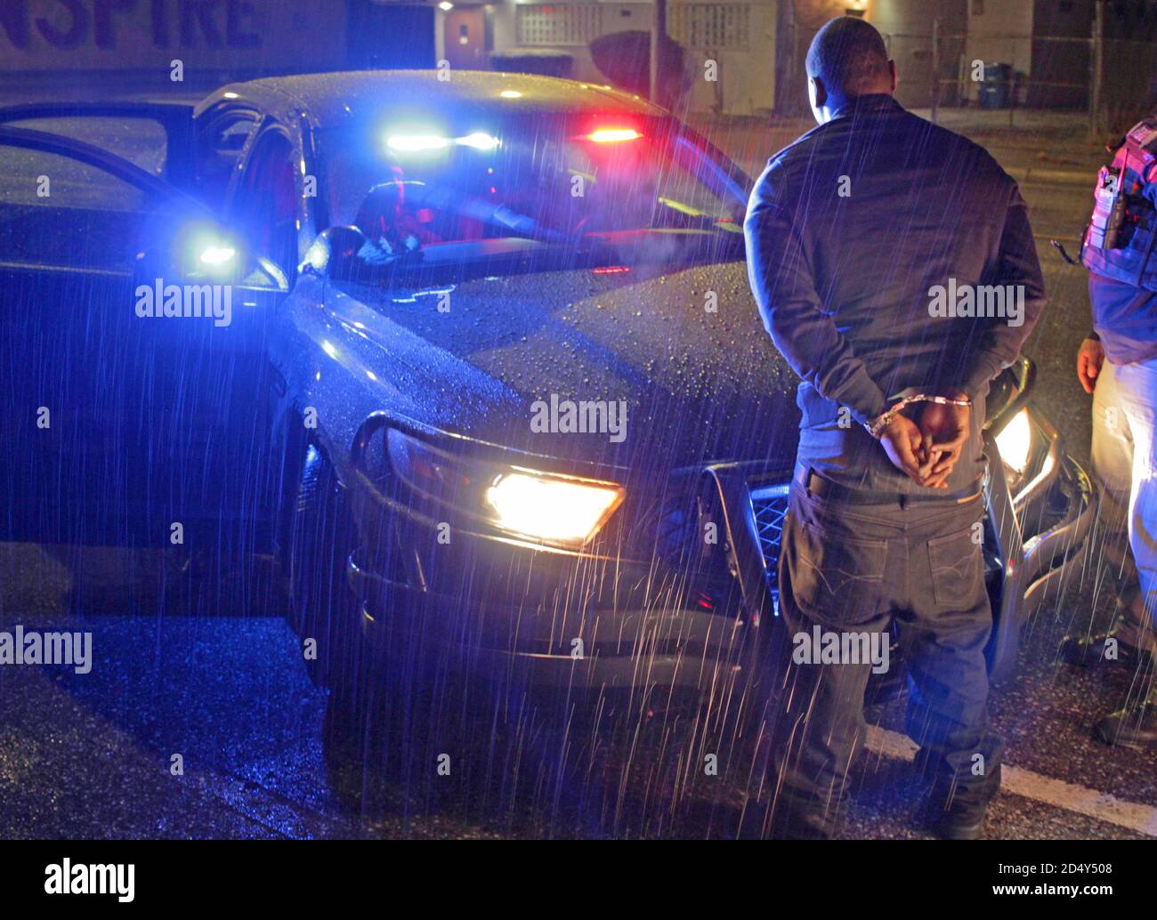 Man detained and handcuffed in the rain, Detroit, Michigan, USA Stock Photo