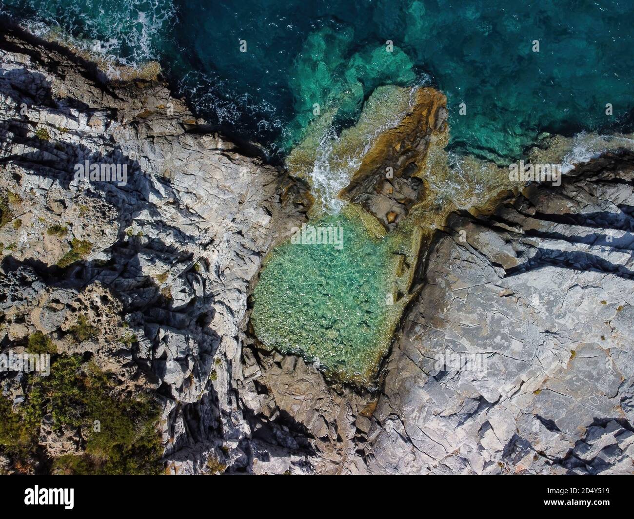 Aerial panoramic view of rocky beach and small pond near Trachila, Messinia, Greece Stock Photo