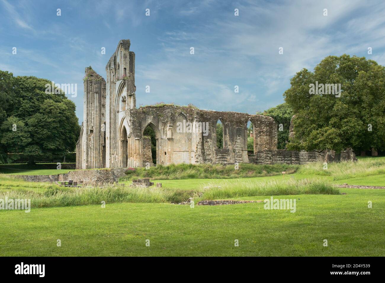 Ruins of Glastonbury Abbey church, Glastonbury, England on a beautiful blue sky day. South walls bays of the former monastery. Landscape format. Stock Photo