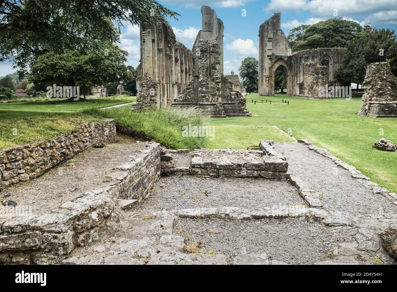 Frederick Bond Bligh's Edgar Chapel area, looking west through the ruins of Glastonbury Abbey, down east end, crossing and nave. Foundation footprint. Stock Photo