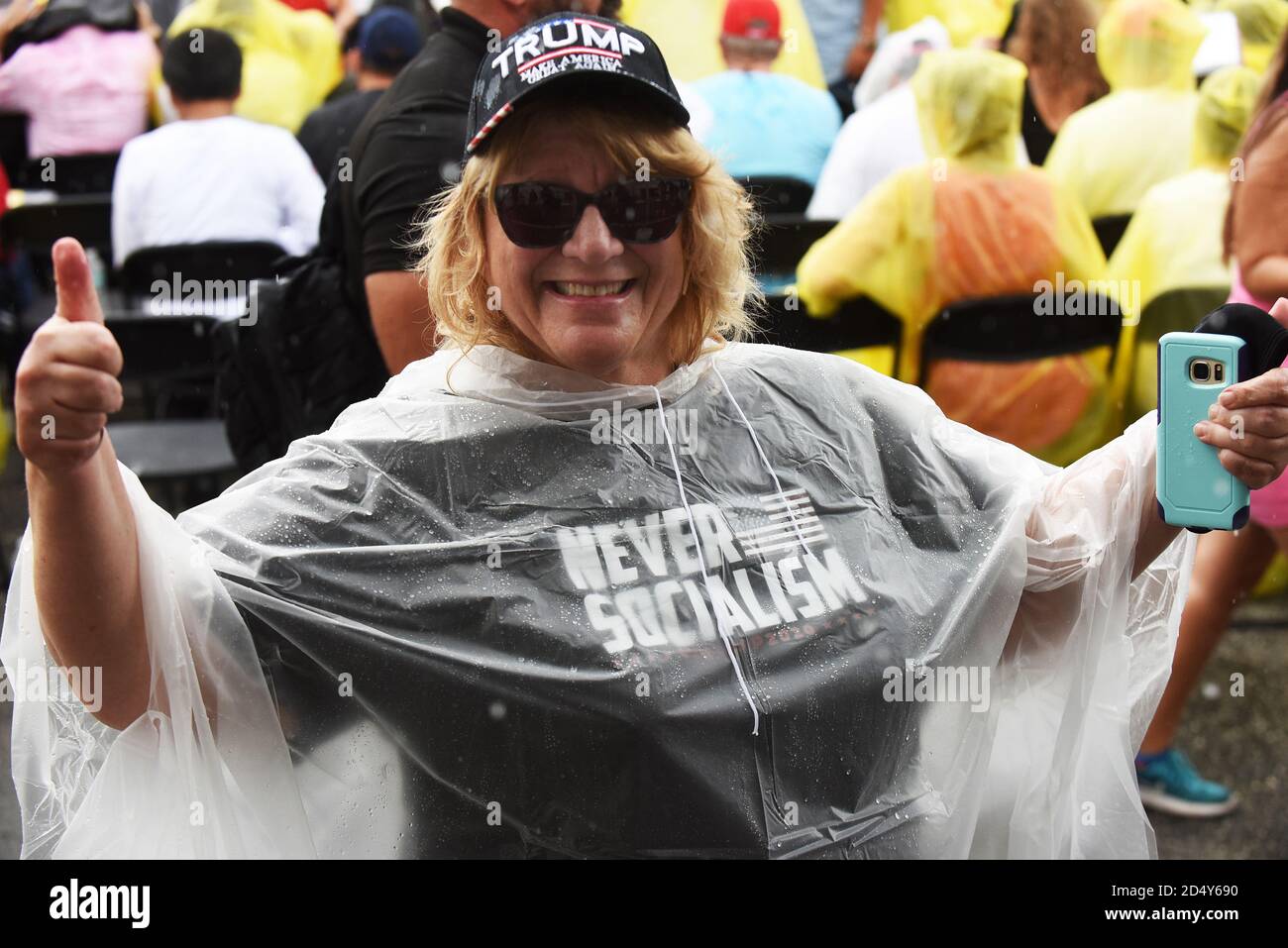 Orlando, Florida, USA. October 11, 2020 - Orlando, Florida, United States - A woman wearing a Never Socialism t-shirt gives a thumbs up while waiting for Donald Trump Jr. to speak at a Fighters Against Socialism campaign rally in support of his father, U.S. President Donald Trump, on October 11, 2020 in Orlando, Florida. UFC fighter Jorge Masvidal also spoke at the rally. (Paul Hennessy/Alamy) Credit: Paul Hennessy/Alamy Live News Stock Photo