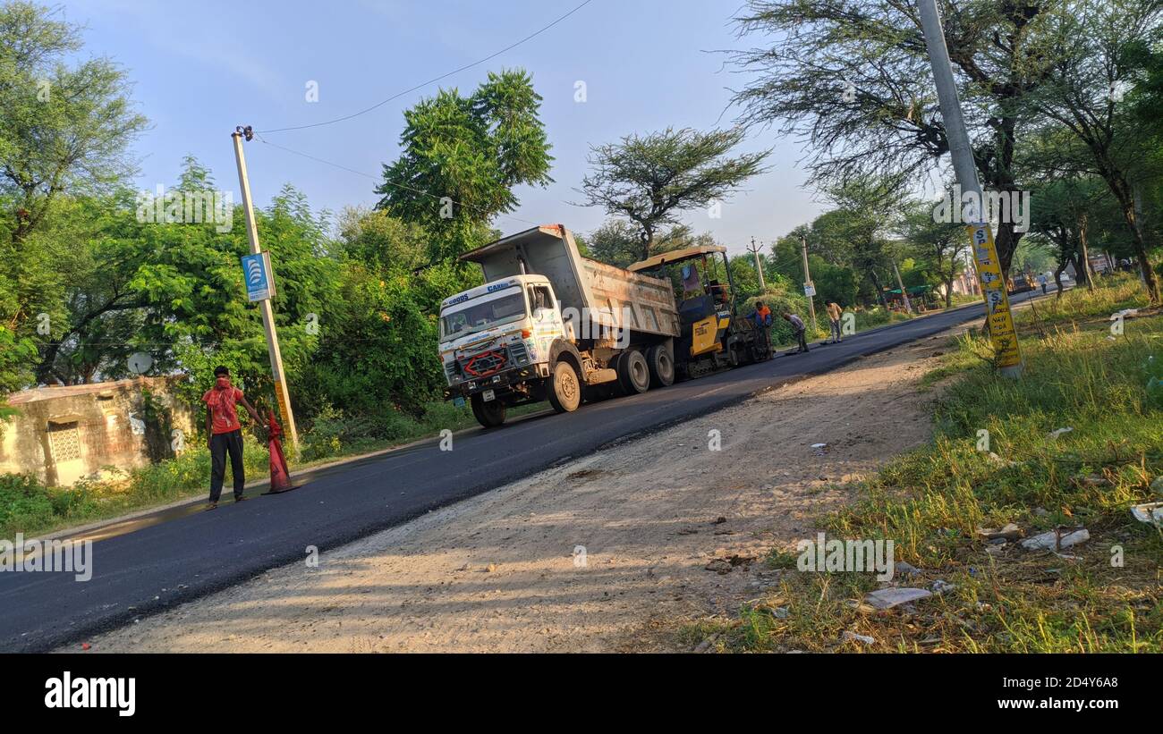 02 October 2020 : Reengus, Jaipur, India / Roller and workers on asphalting and repair of state highway road. Stock Photo