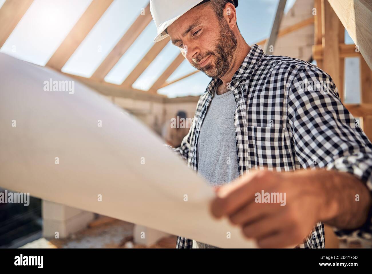 Focused professional architect looking at the blueprint Stock Photo