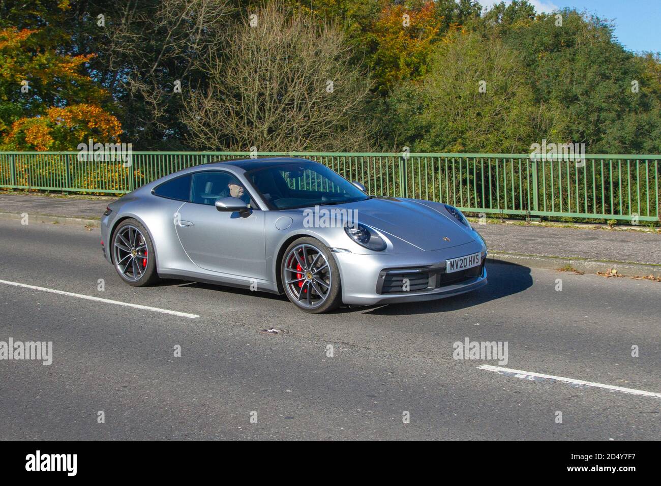 2020 silver Porsche 911 Carrera 4S S-A; Vehicular traffic, moving vehicles, cars, vehicle driving on UK roads, motors, motoring on the UK road network. Stock Photo