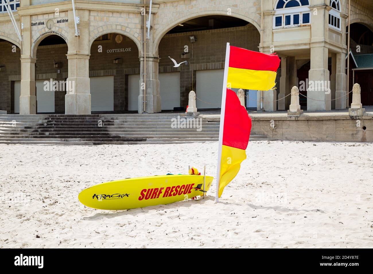 Perth, Australia - October 7th 2020: Surf lifesavers flag and board on the beach outside Cottesloe Indiana Tearooms Stock Photo