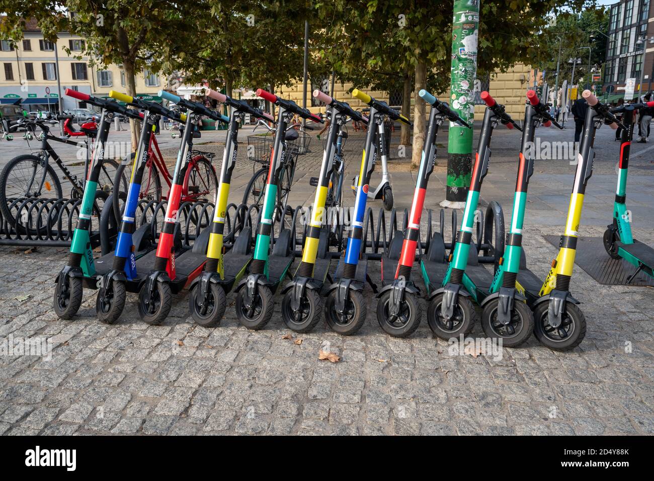 Electric Scooters For Public Share Standing Outside In Milan City Center,  Rent urban vehicle with smartphone application. Zero emission green eco  ener Stock Photo - Alamy