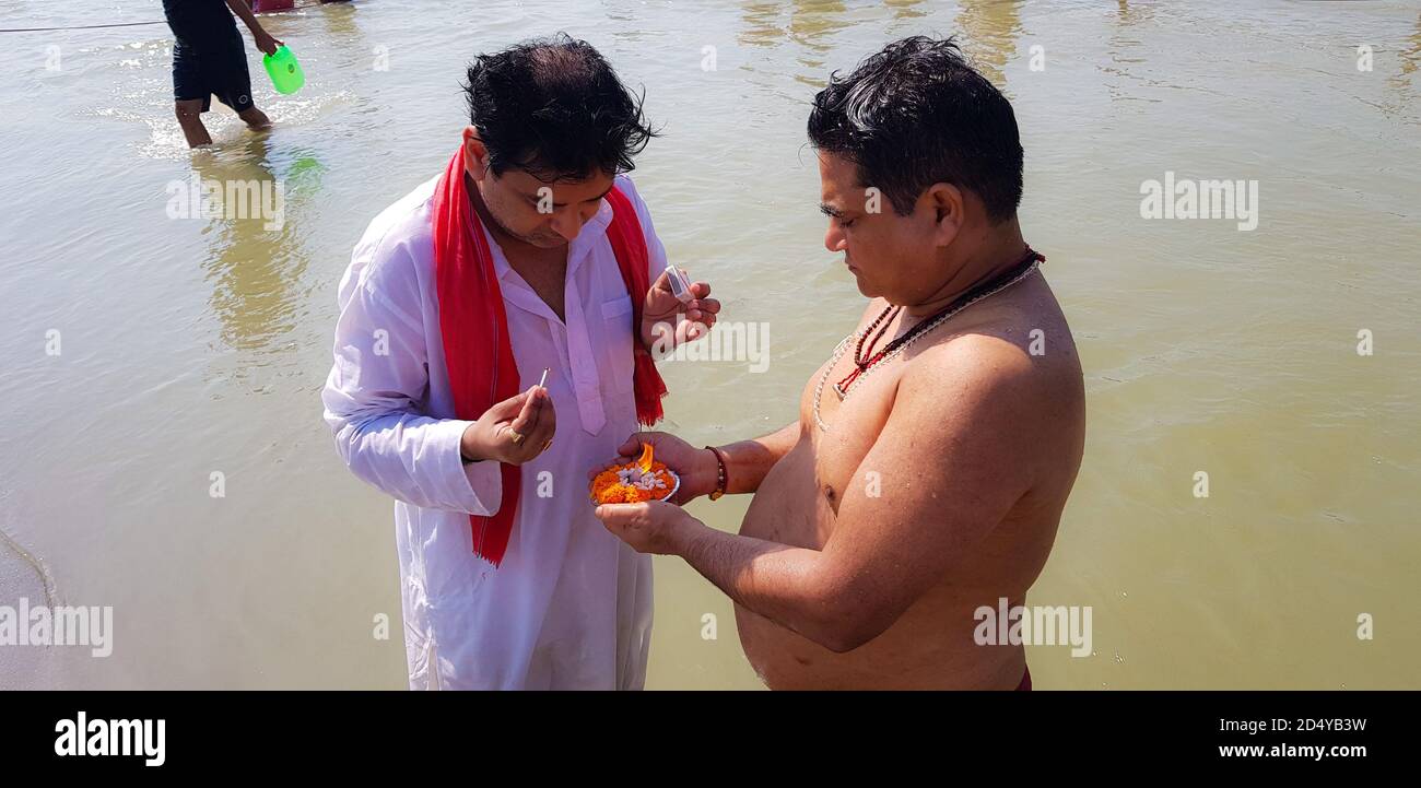 Garhmukteshwar, Uttar Pradesh/India - October 4, 2020: Worshiping ganges river after Submerging the remains after a funeral Stock Photo