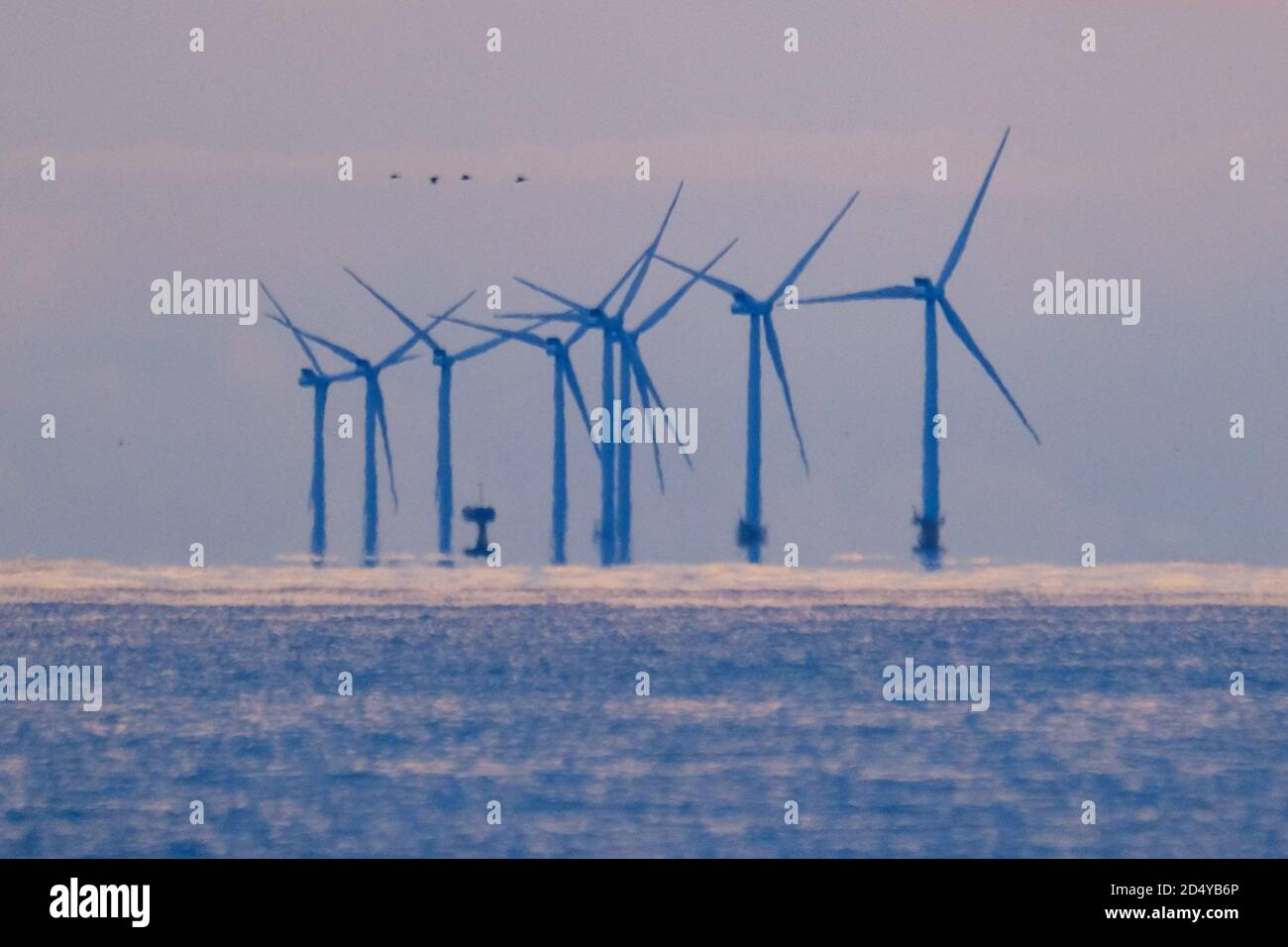 Worthing Beach, Worthing, UK. 12th Oct, 2020. Rampion Offshore Wind Farm on a peaceful October Monday morning. Completed in 2018, Rampion Offshore Wind Farm generates enough electricity to power the equivalent of almost 350000 UK homes. Picture by Credit: Julie Edwards/Alamy Live News Stock Photo
