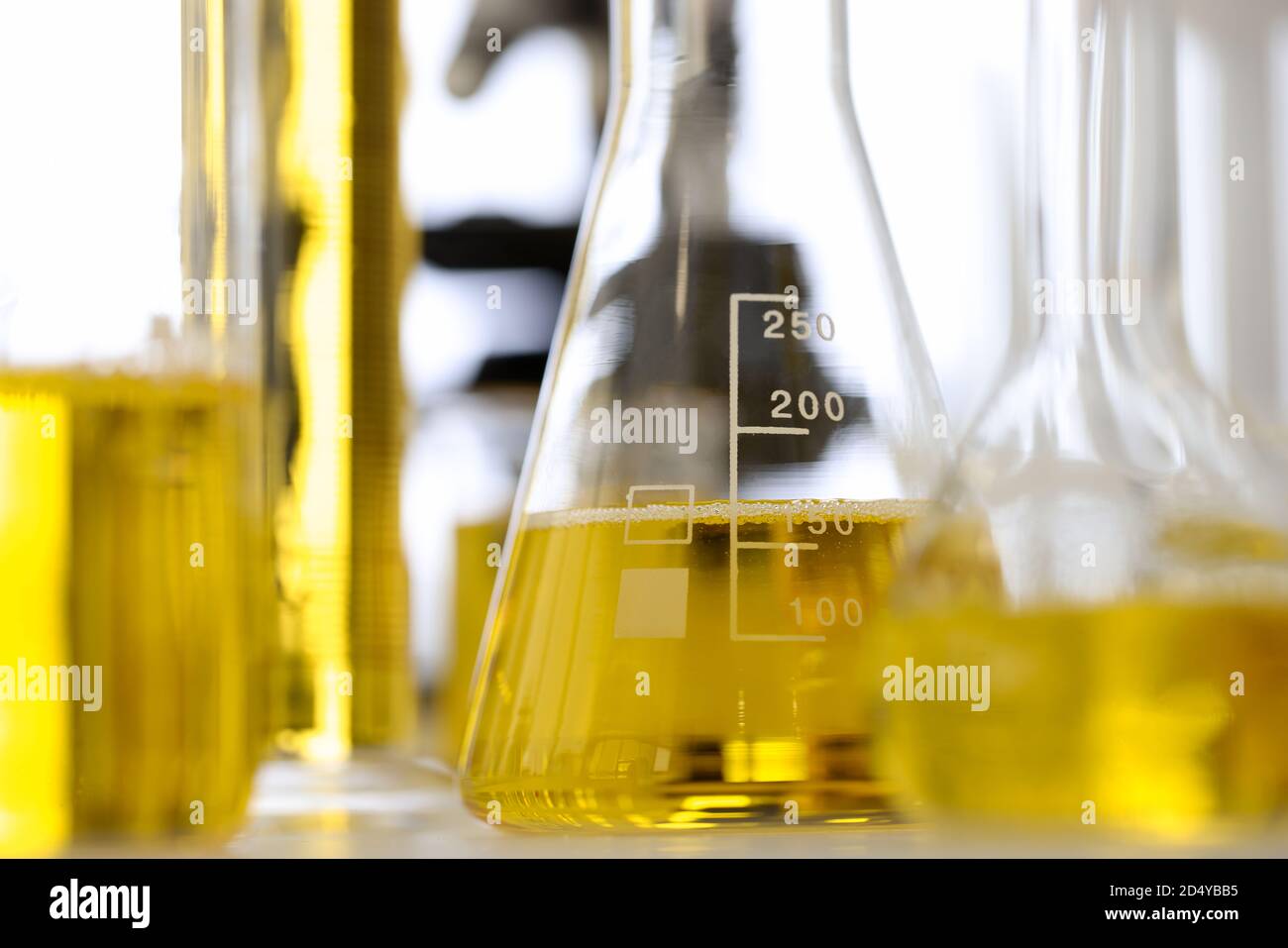 Glass test tubes and flasks stand on table in pharmaceutical laboratory ...