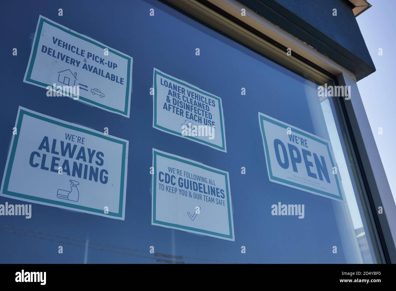 Health and safety signs are seen at a car dealership in Oregon City, Ore., on October 6, 2020, amid the coronavirus pandemic. Stock Photo