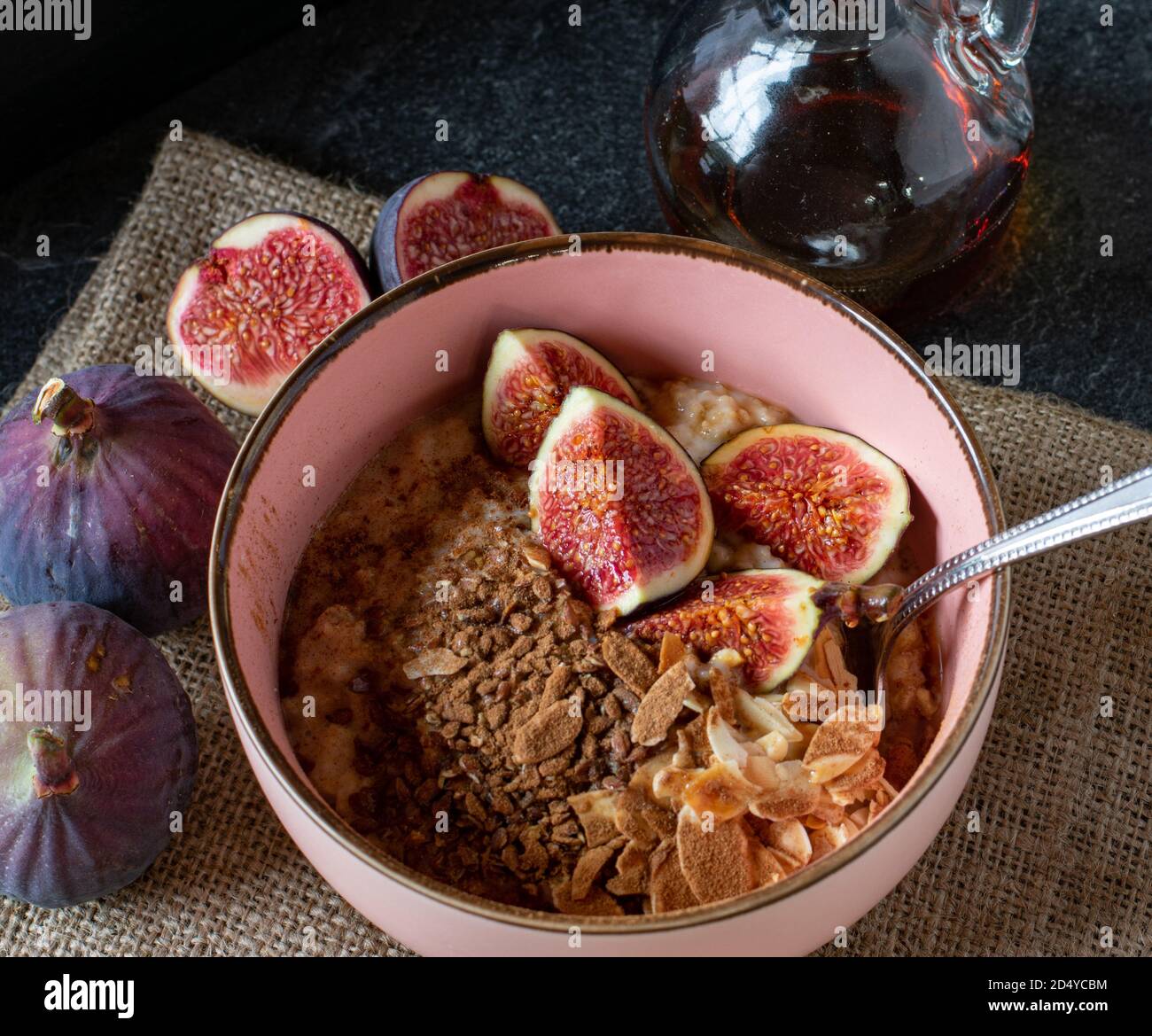 healthy oatmeal cereal bowl with roasted almonds, cinnamon and figs served in a bowl without milk Stock Photo
