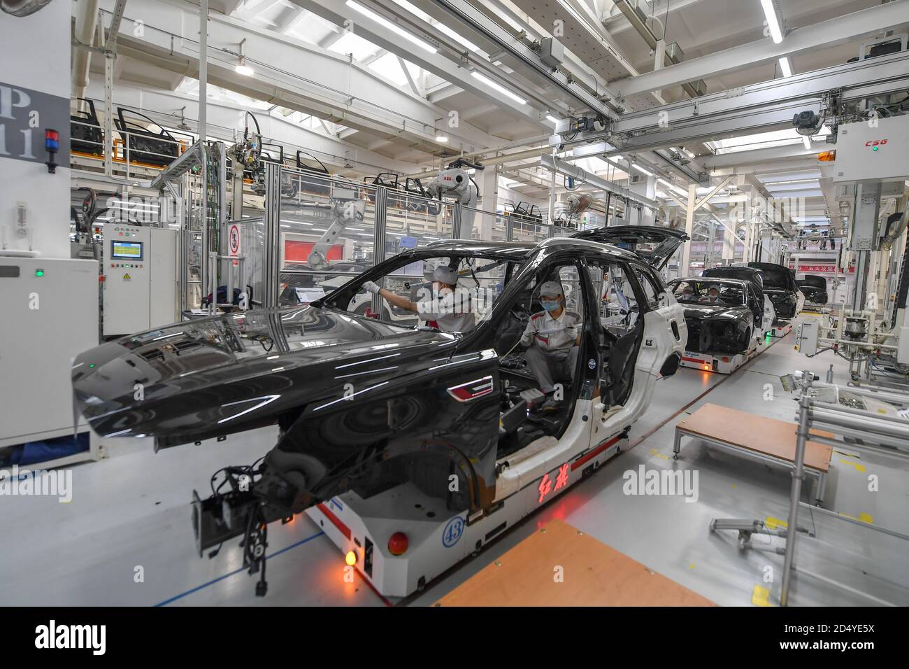 Changchun, China's Jilin Province. 23rd Sep, 2020. Workers assemble cars at a factory of the First Automotive Works (FAW) Group Co., Ltd. in Changchun, capital of northeast China's Jilin Province, Sept. 23, 2020. China's leading automaker First Automotive Works (FAW) Group Co., Ltd. sold 2,656,744 vehicles in the first three quarters of the year, up 8 percent year on year, according to corporate sources. Credit: Zhang Nan/Xinhua/Alamy Live News Stock Photo