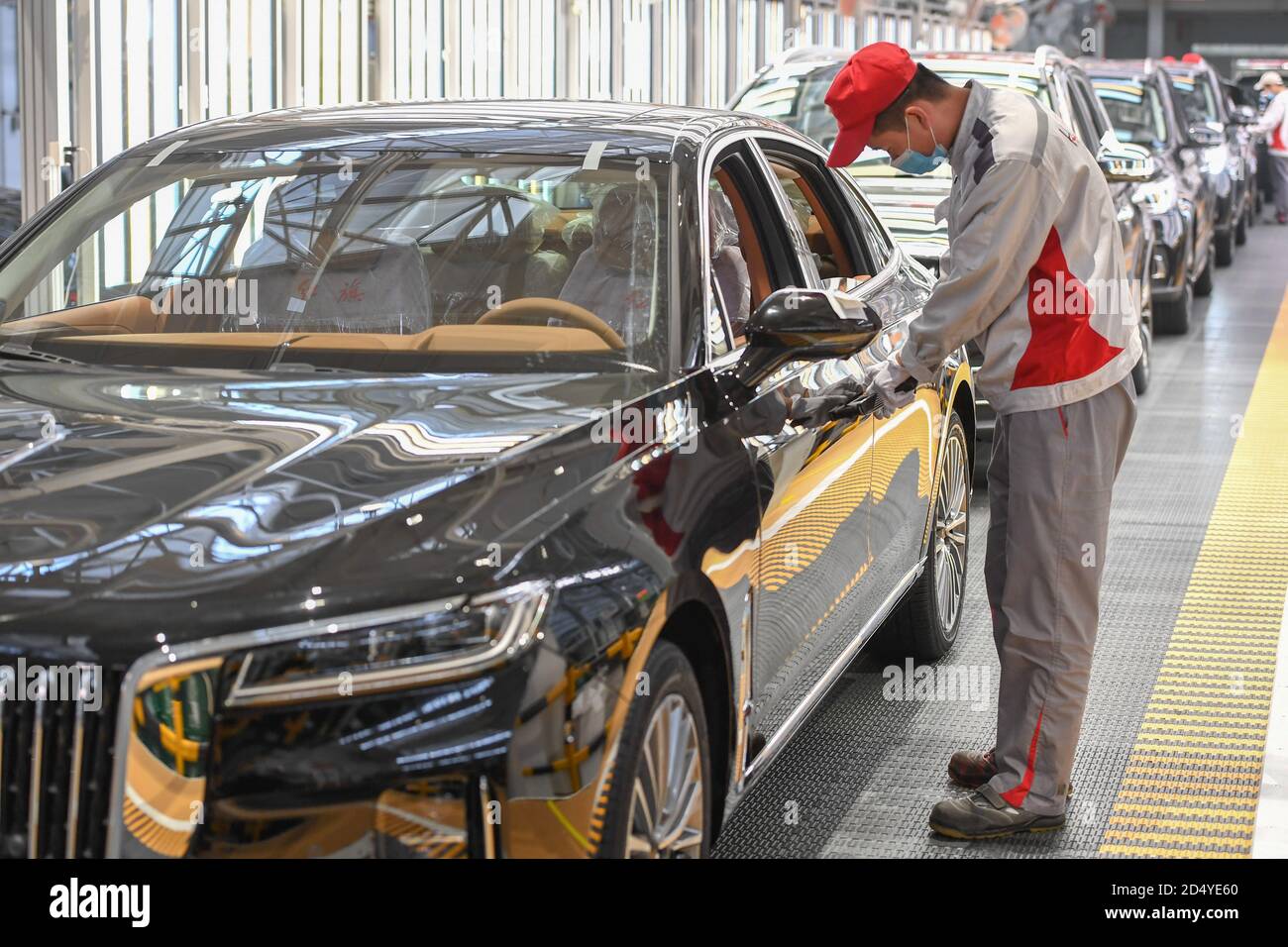 Changchun, China's Jilin Province. 23rd Sep, 2020. A worker checks a car at a factory of the First Automotive Works (FAW) Group Co., Ltd. in Changchun, capital of northeast China's Jilin Province, Sept. 23, 2020. China's leading automaker First Automotive Works (FAW) Group Co., Ltd. sold 2,656,744 vehicles in the first three quarters of the year, up 8 percent year on year, according to corporate sources. Credit: Zhang Nan/Xinhua/Alamy Live News Stock Photo