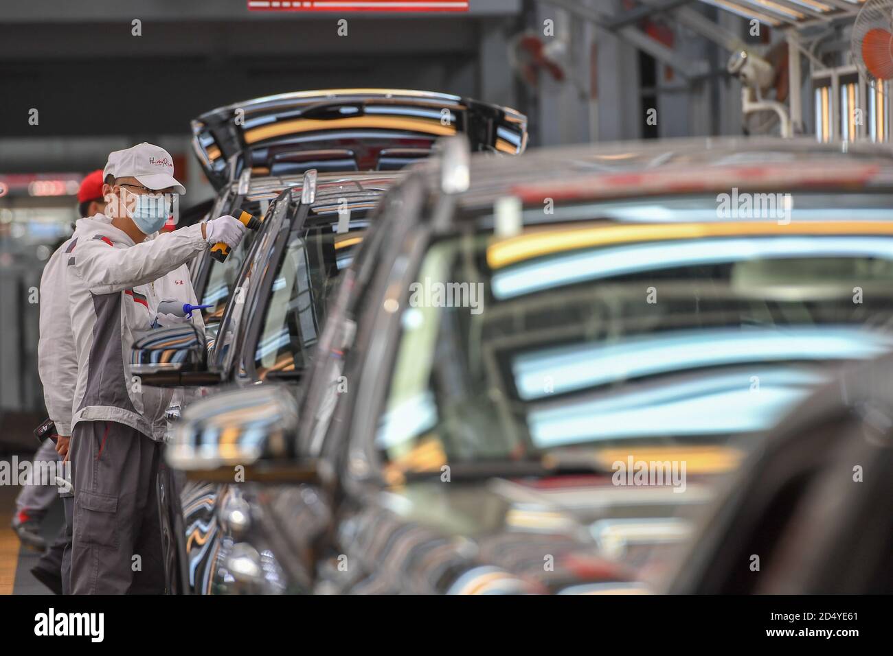 Changchun, China's Jilin Province. 23rd Sep, 2020. Workers check cars at a factory of the First Automotive Works (FAW) Group Co., Ltd. in Changchun, capital of northeast China's Jilin Province, Sept. 23, 2020. China's leading automaker First Automotive Works (FAW) Group Co., Ltd. sold 2,656,744 vehicles in the first three quarters of the year, up 8 percent year on year, according to corporate sources. Credit: Zhang Nan/Xinhua/Alamy Live News Stock Photo